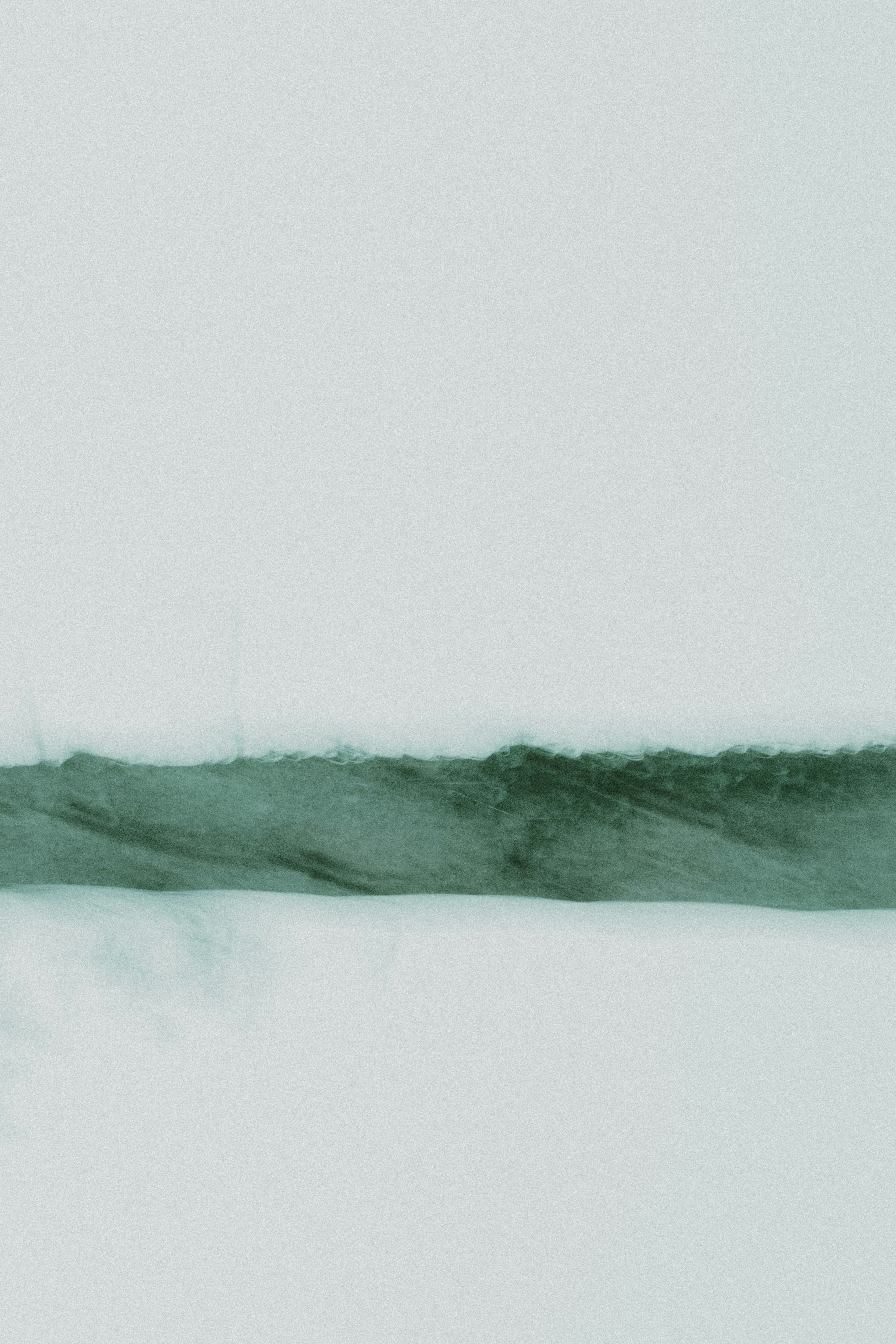 A black and white photo of a bird flying in the sky