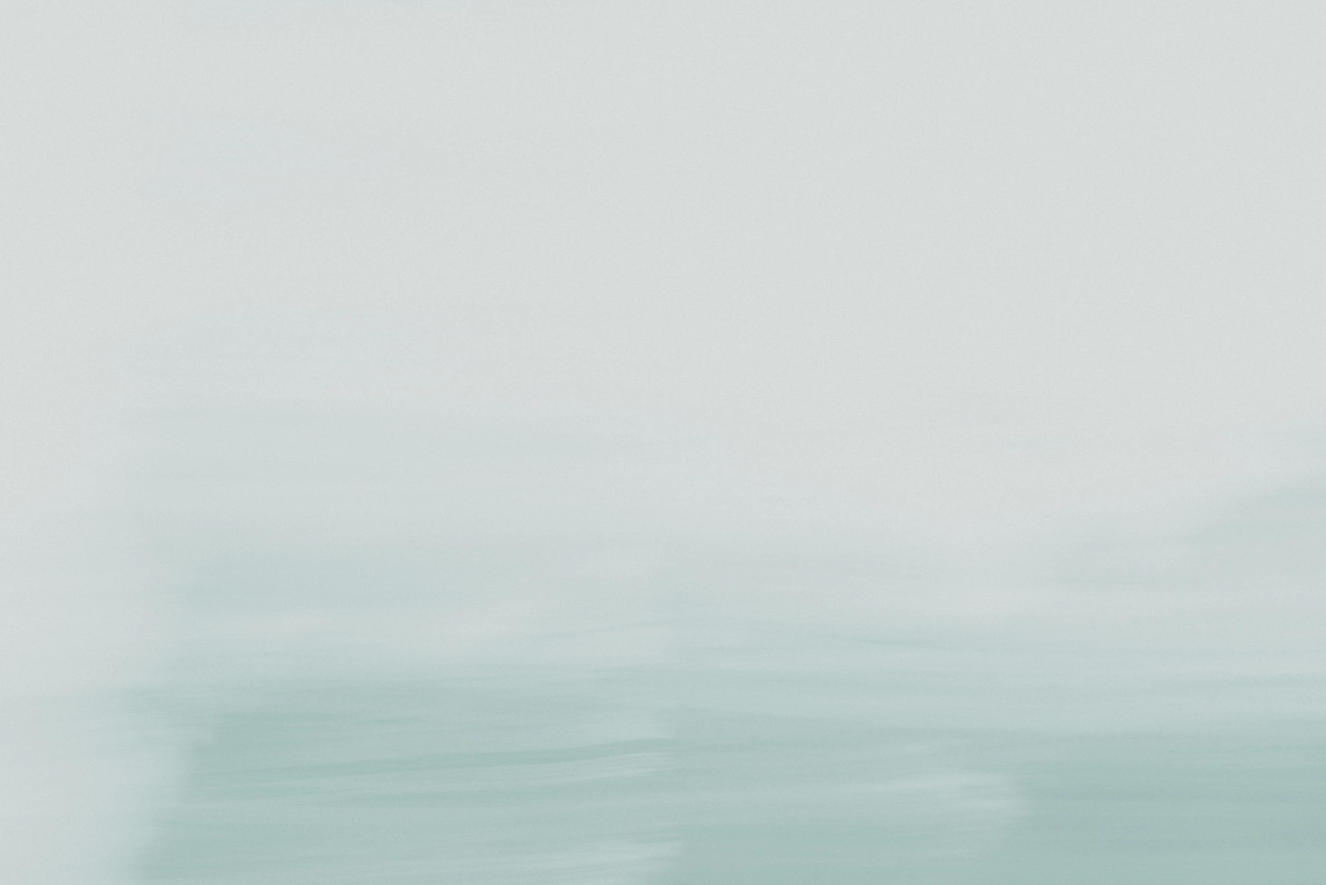 A blurry photo of a person on a surfboard