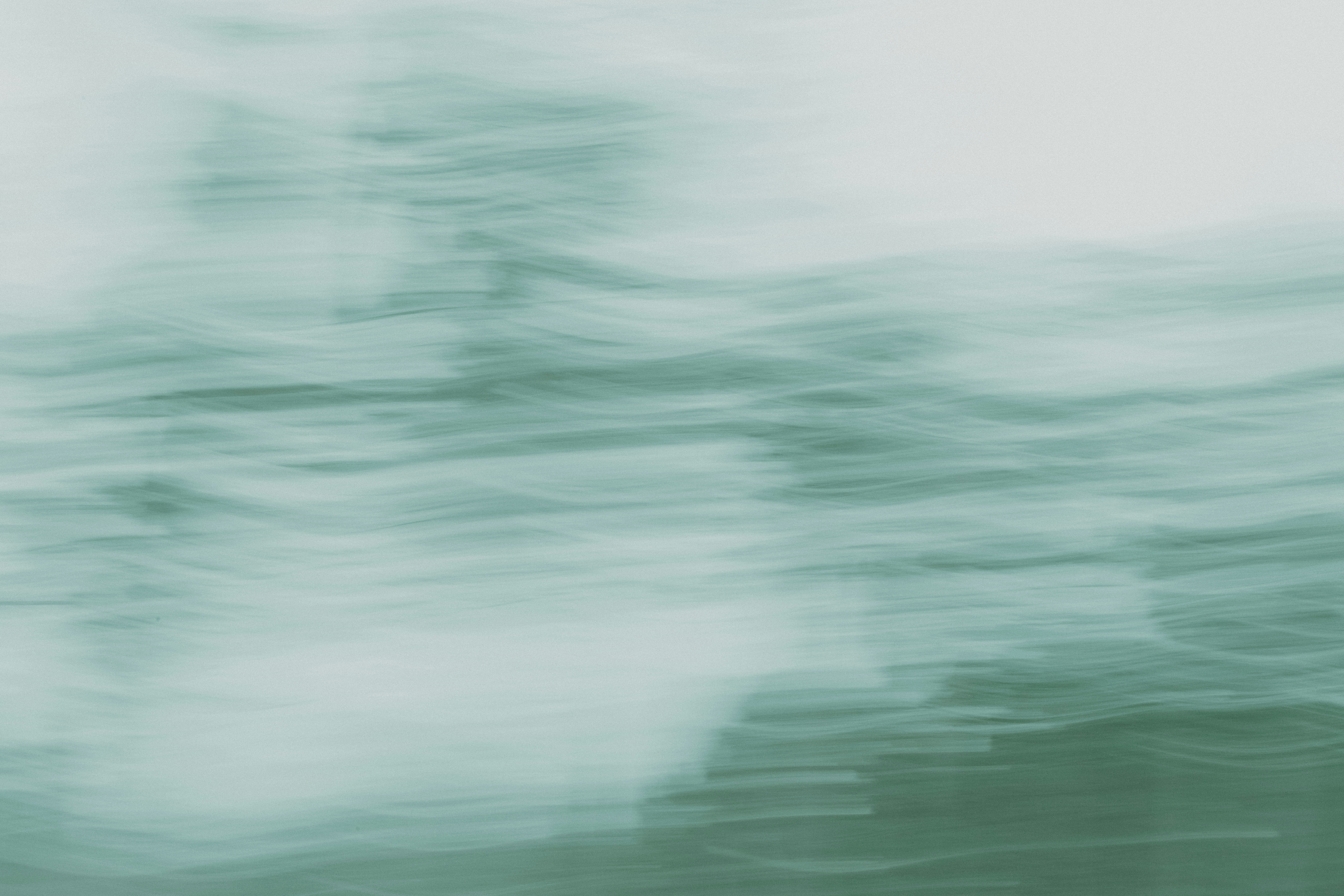 A blurry photo of a bird flying in the sky