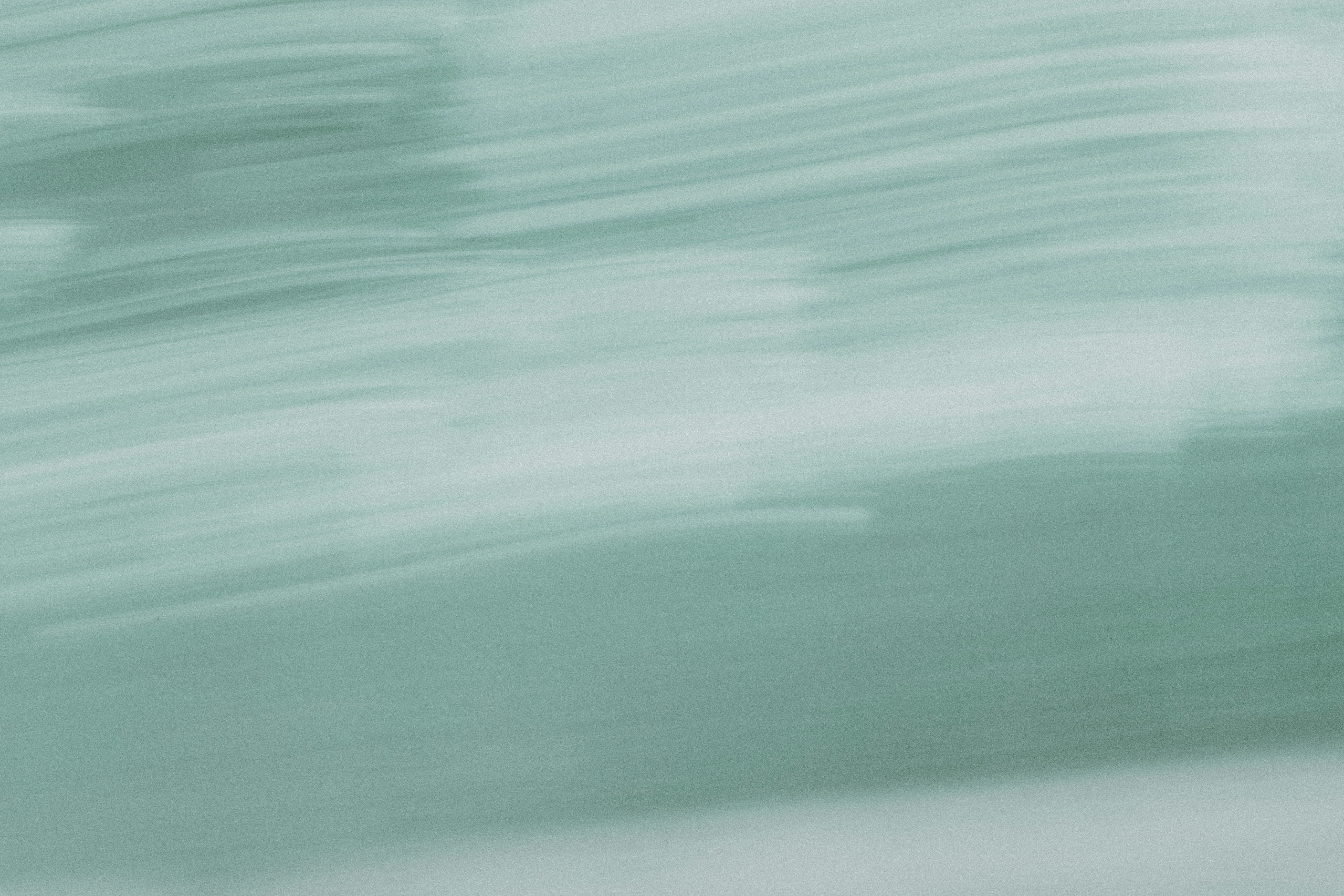 A blurry photo of a person riding a surfboard