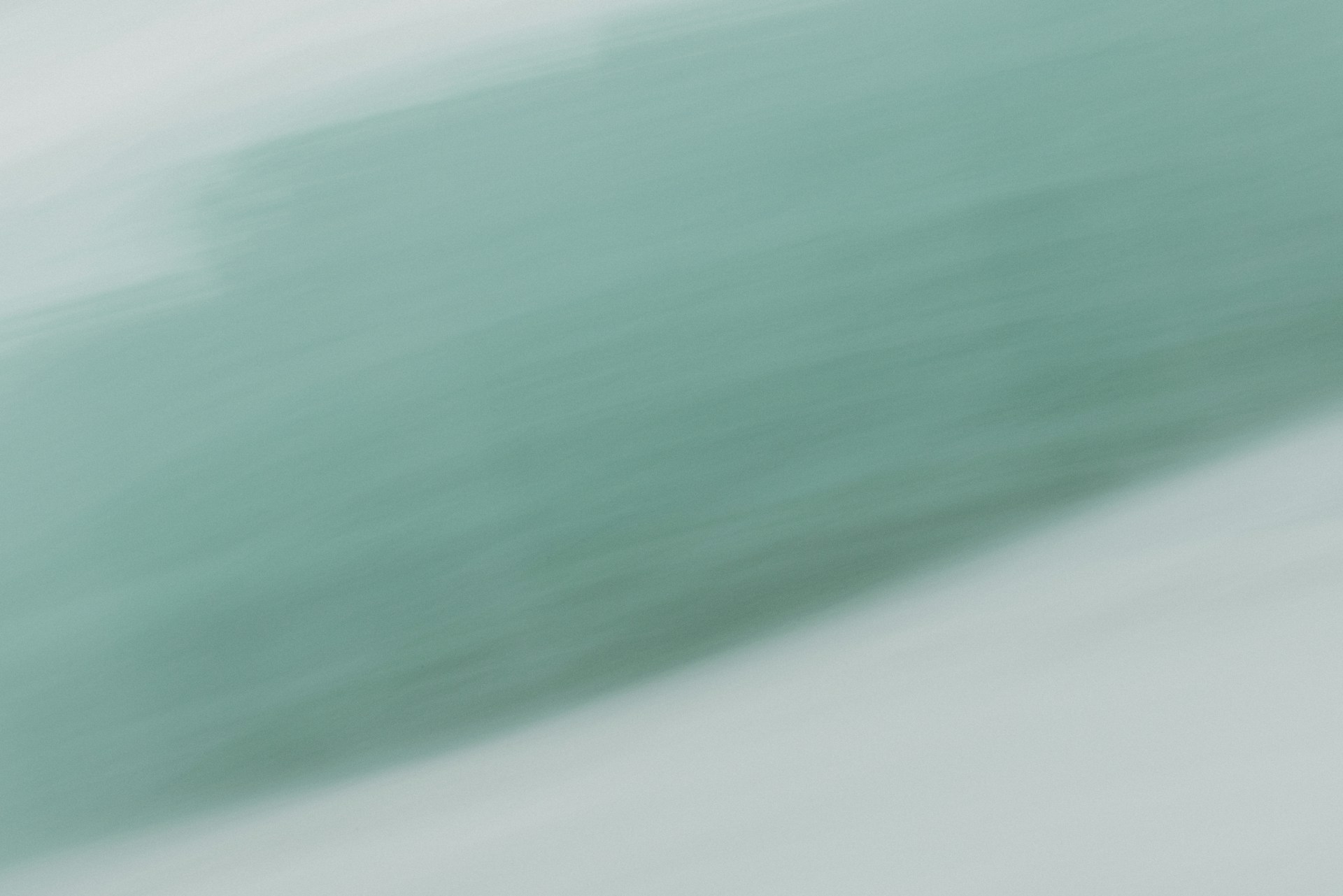 A blurry photo of a person holding a cell phone