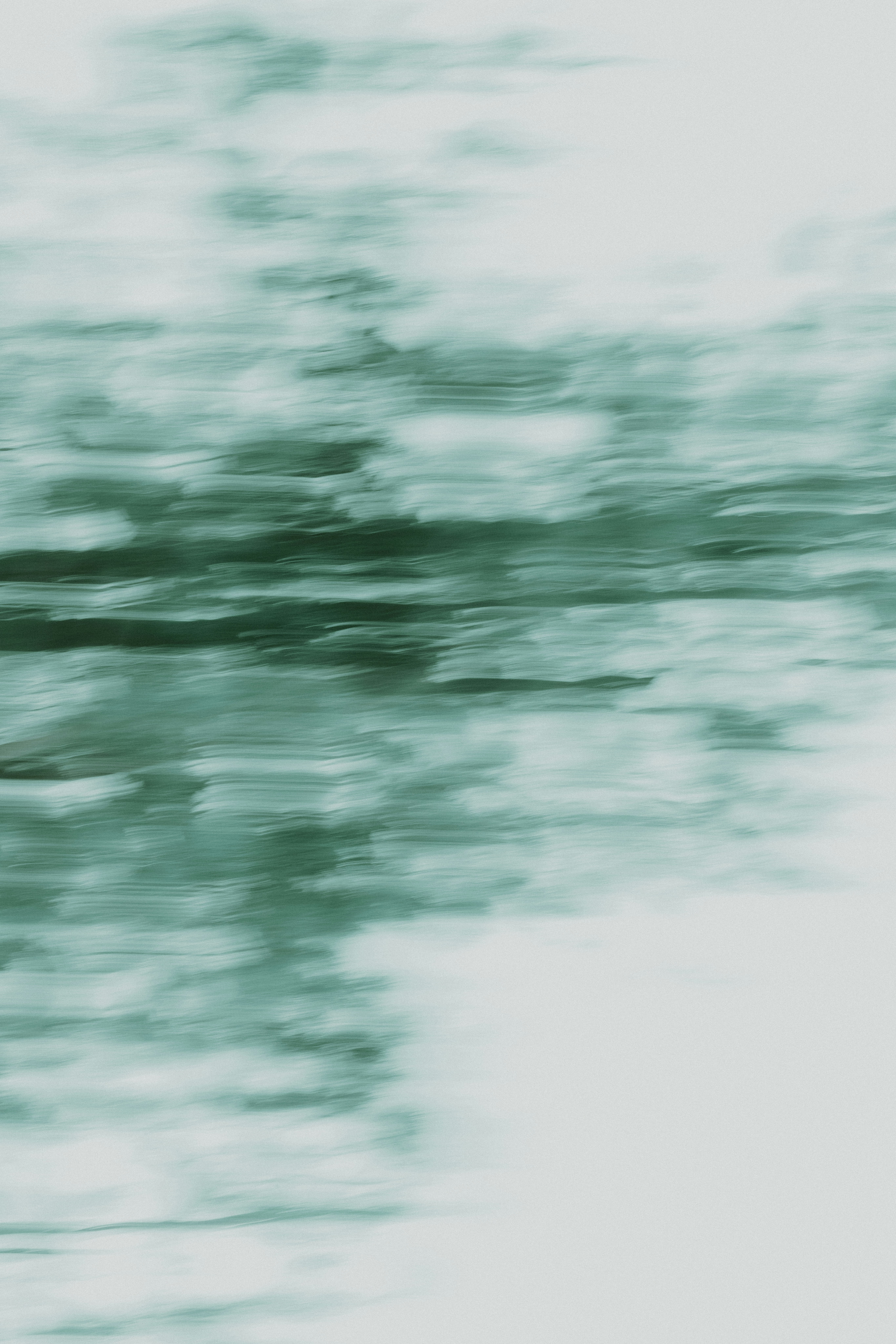 A blurry photo of a bird flying in the sky