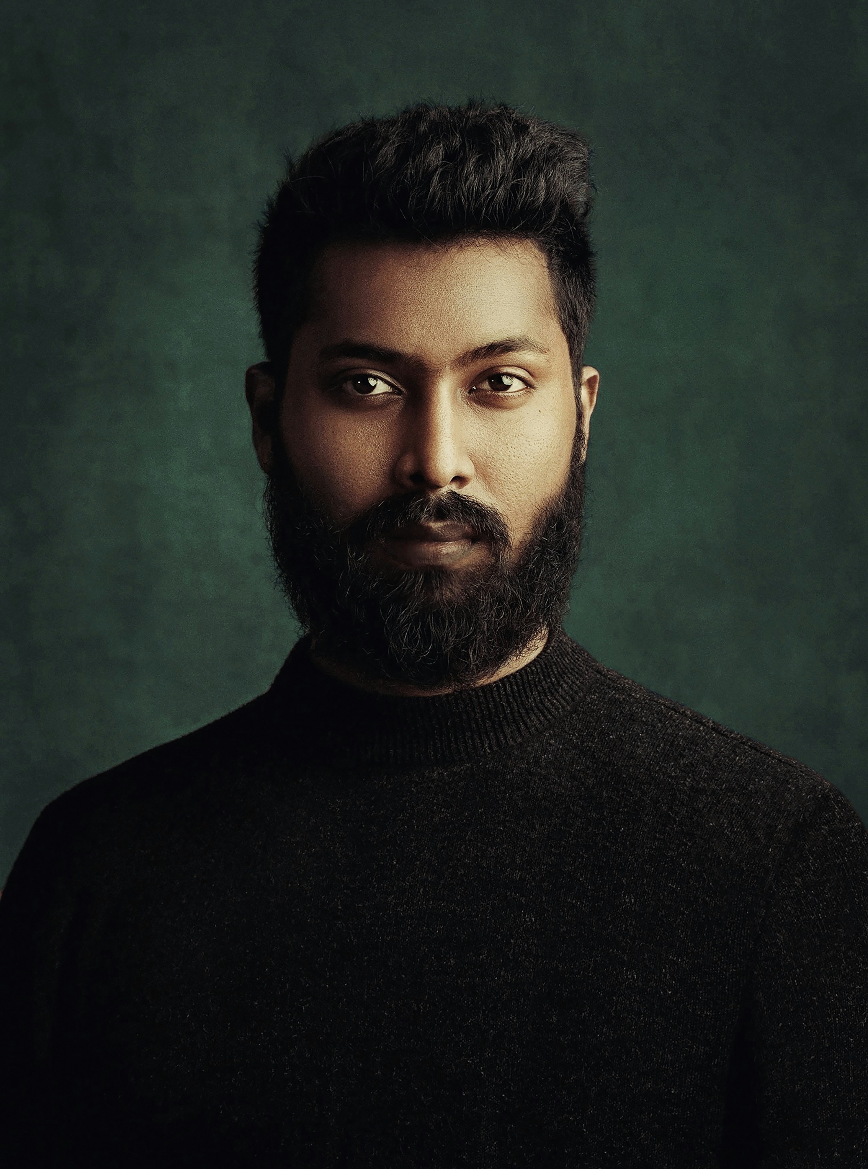 A man with a beard wearing a black sweater