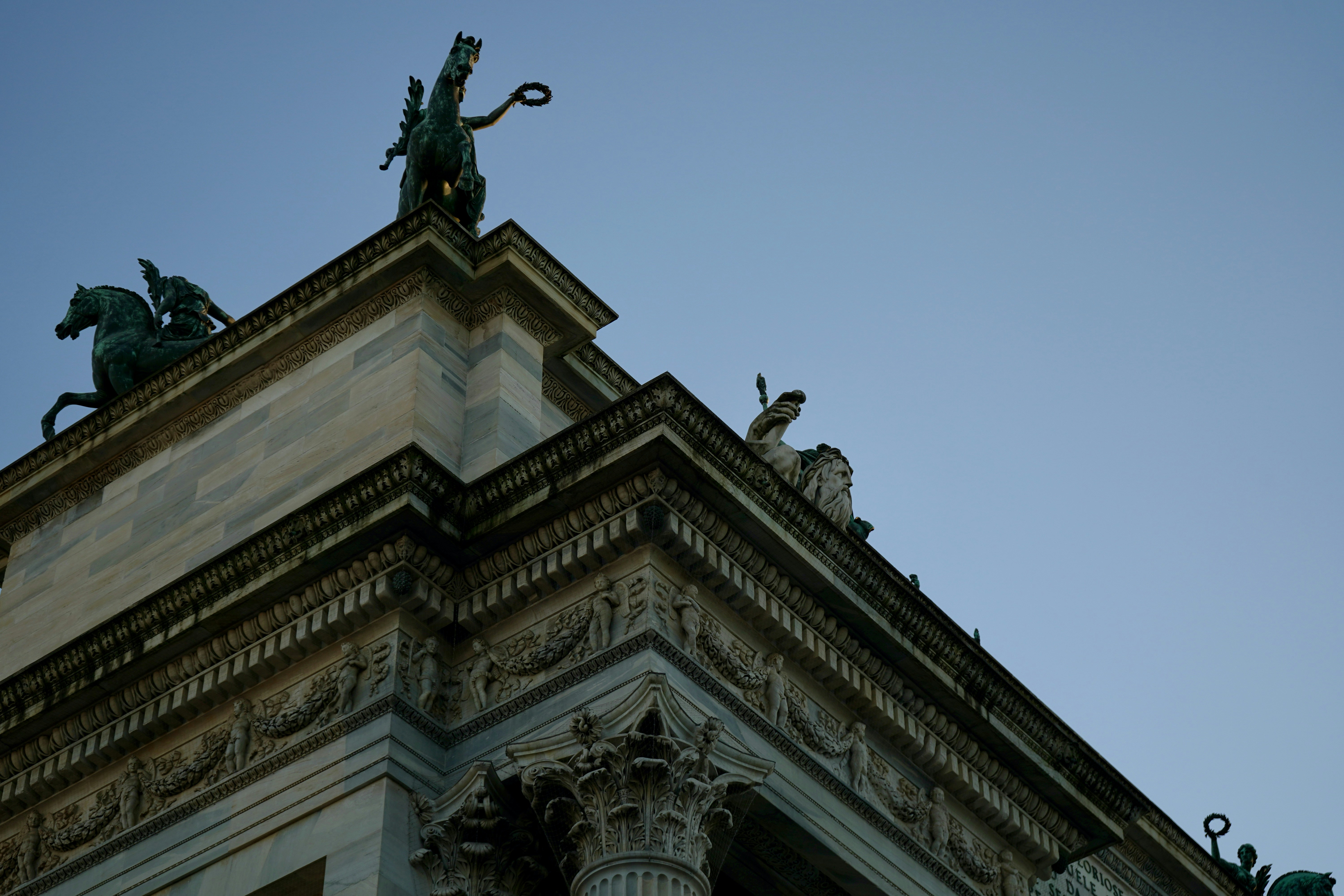 A tall building with statues on top of it