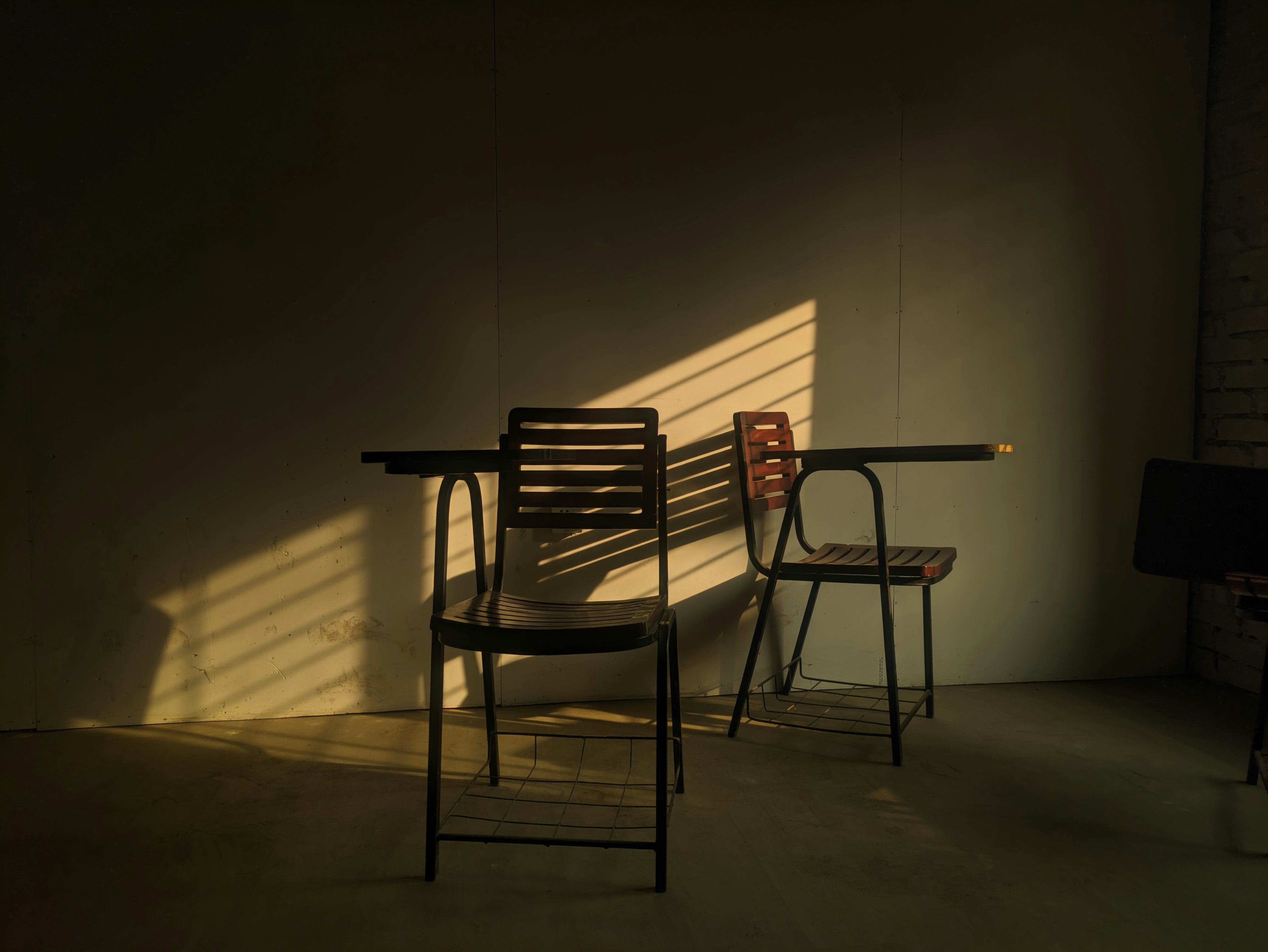 Two chairs and a table in a dimly lit room