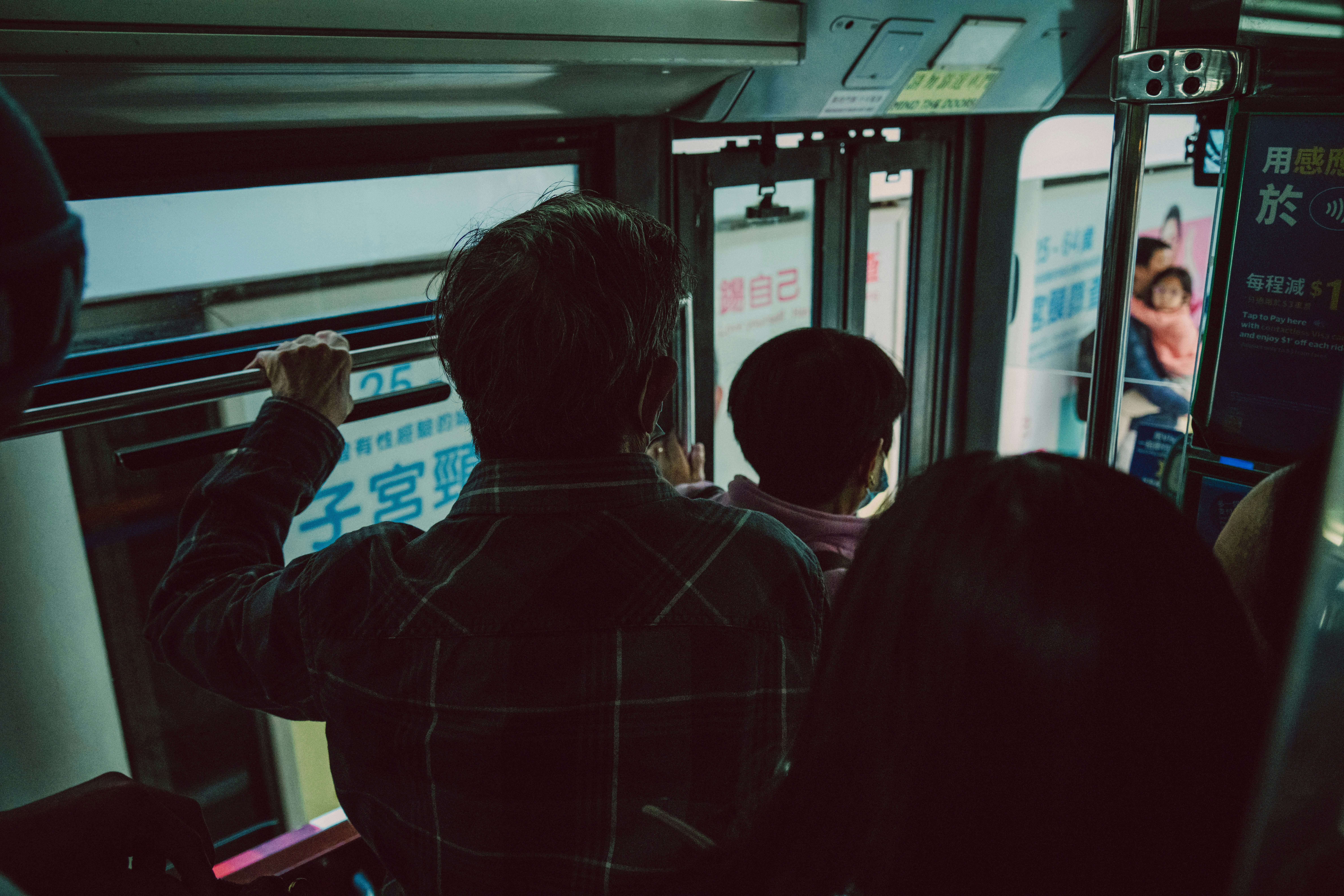 A group of people riding on a bus at night