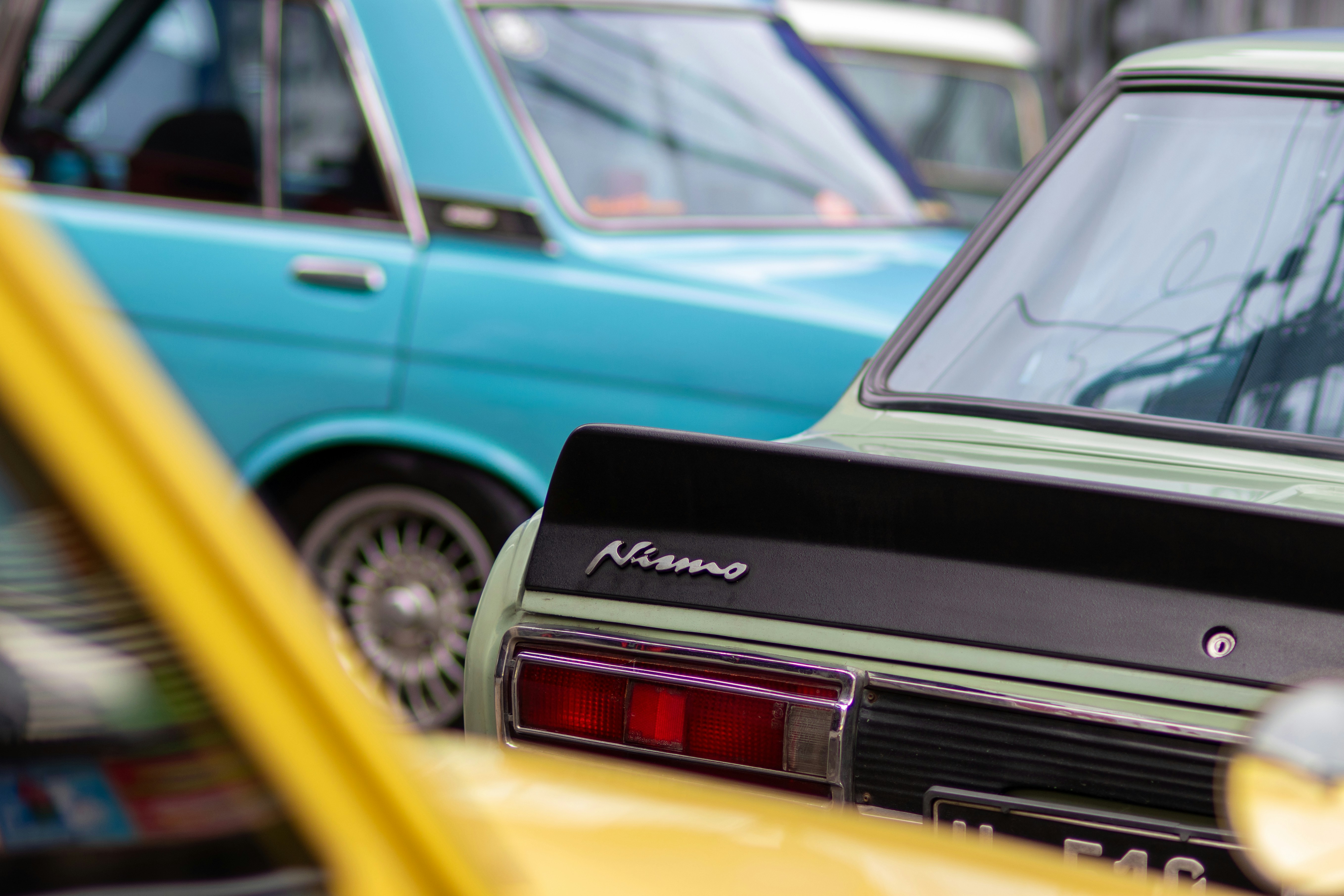 A group of cars parked next to each other in a parking lot