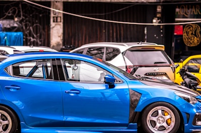 A blue car parked in a parking lot
