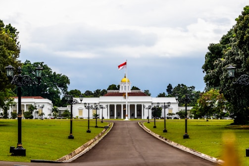 A large white building with a flag on top of it