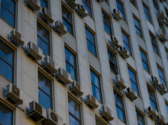 A tall building with lots of windows and a clock