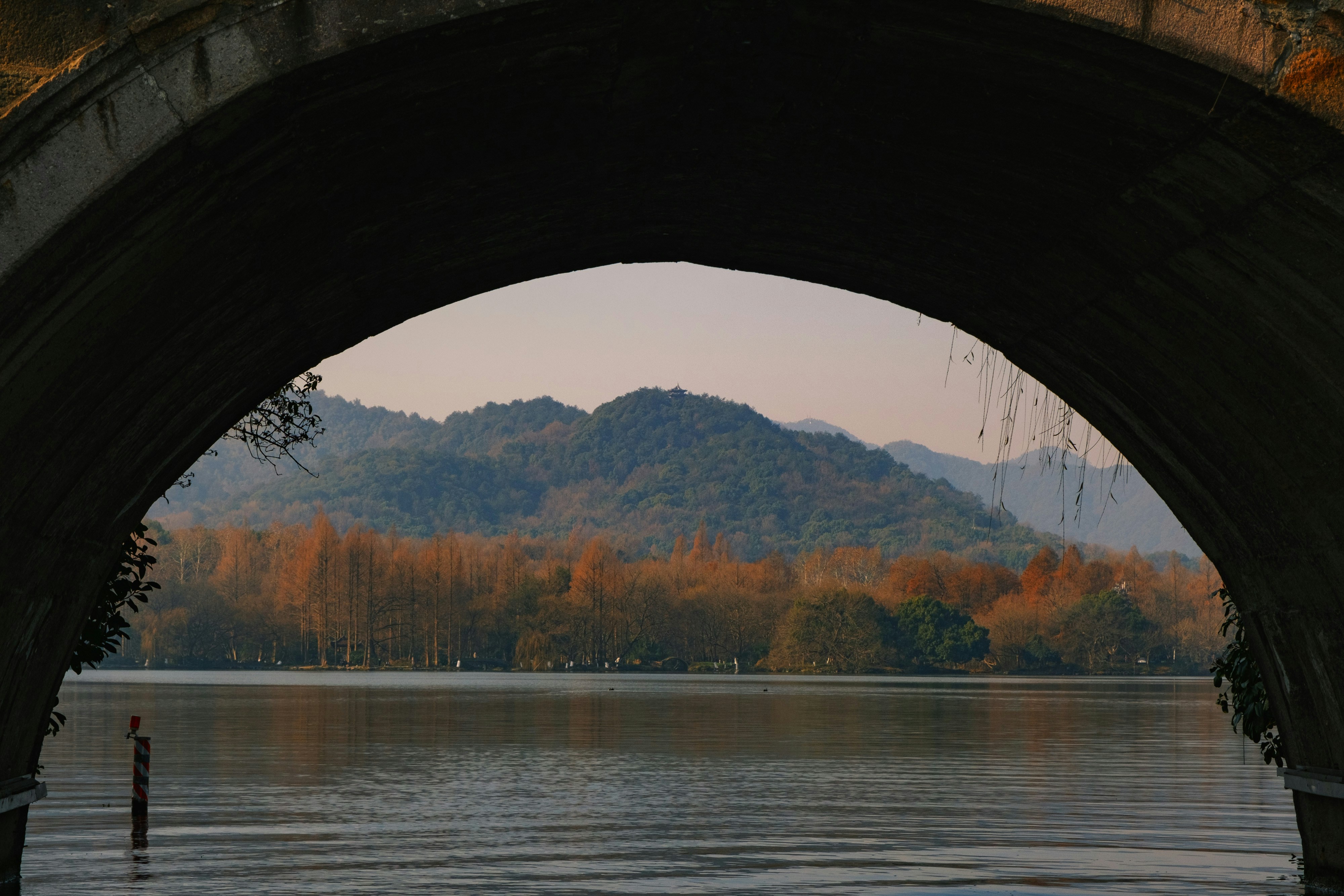 A large body of water under a bridge