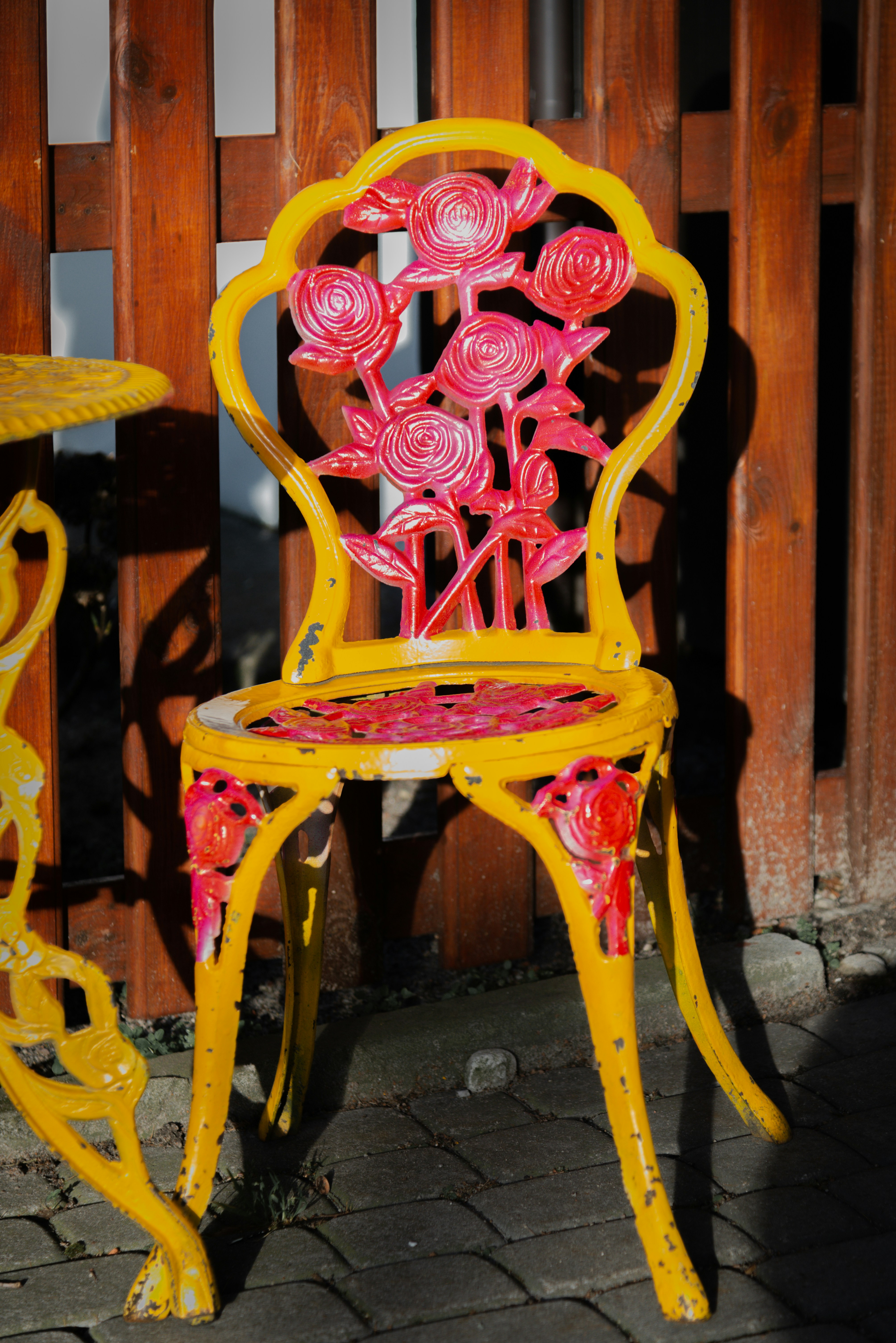 A yellow chair and a pink chair sitting next to each other
