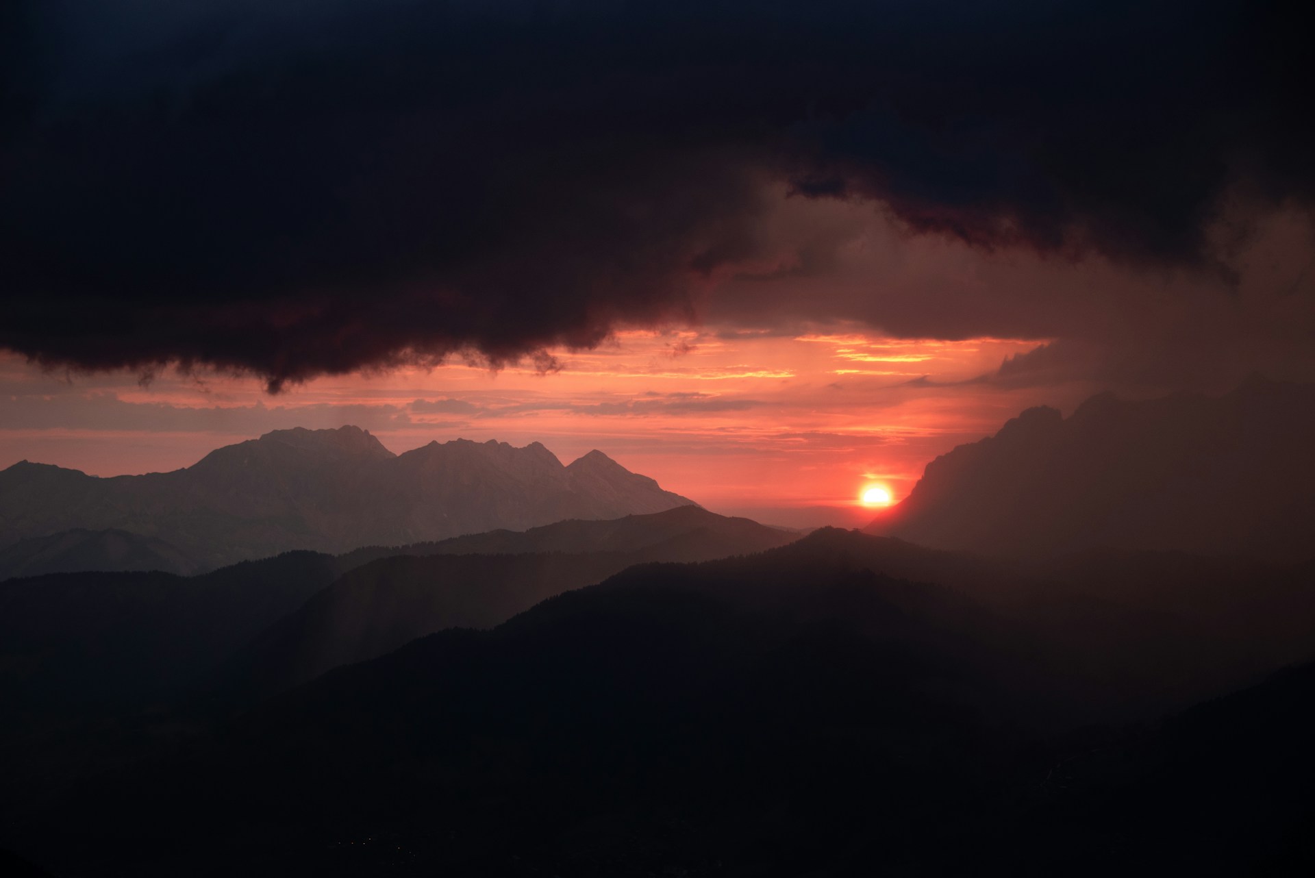 The sun is setting over a mountain range