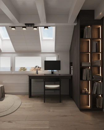 A room with a bed, a desk and a television