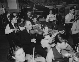 An orchestra rehearses with violins and other instruments.