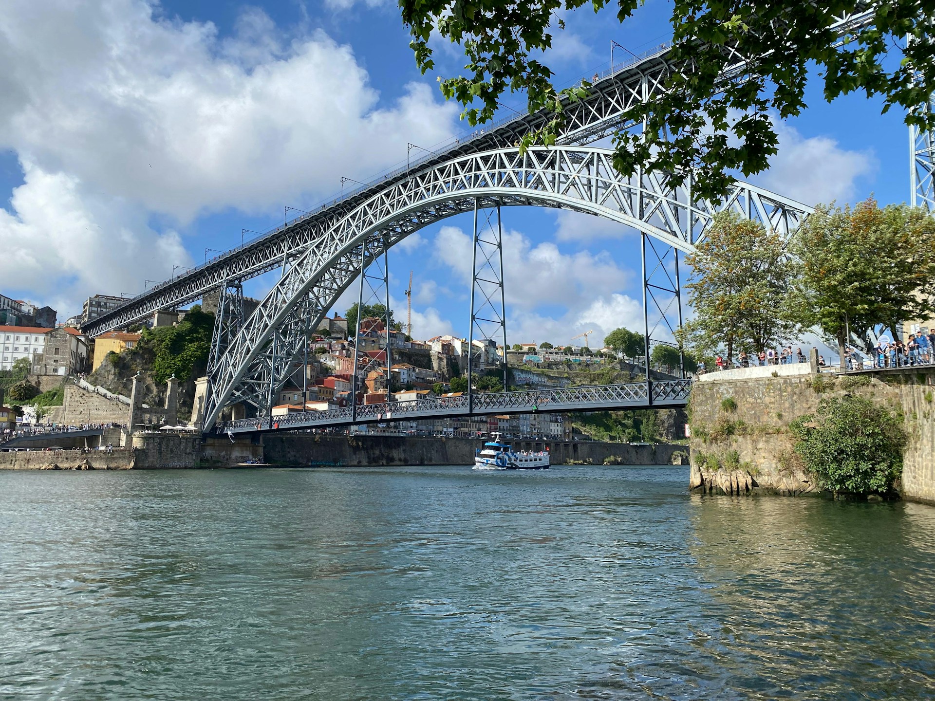 A bridge over a river with a boat on it