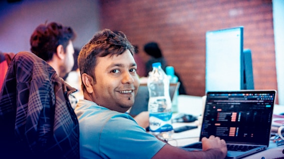 A man sitting in front of a laptop computer