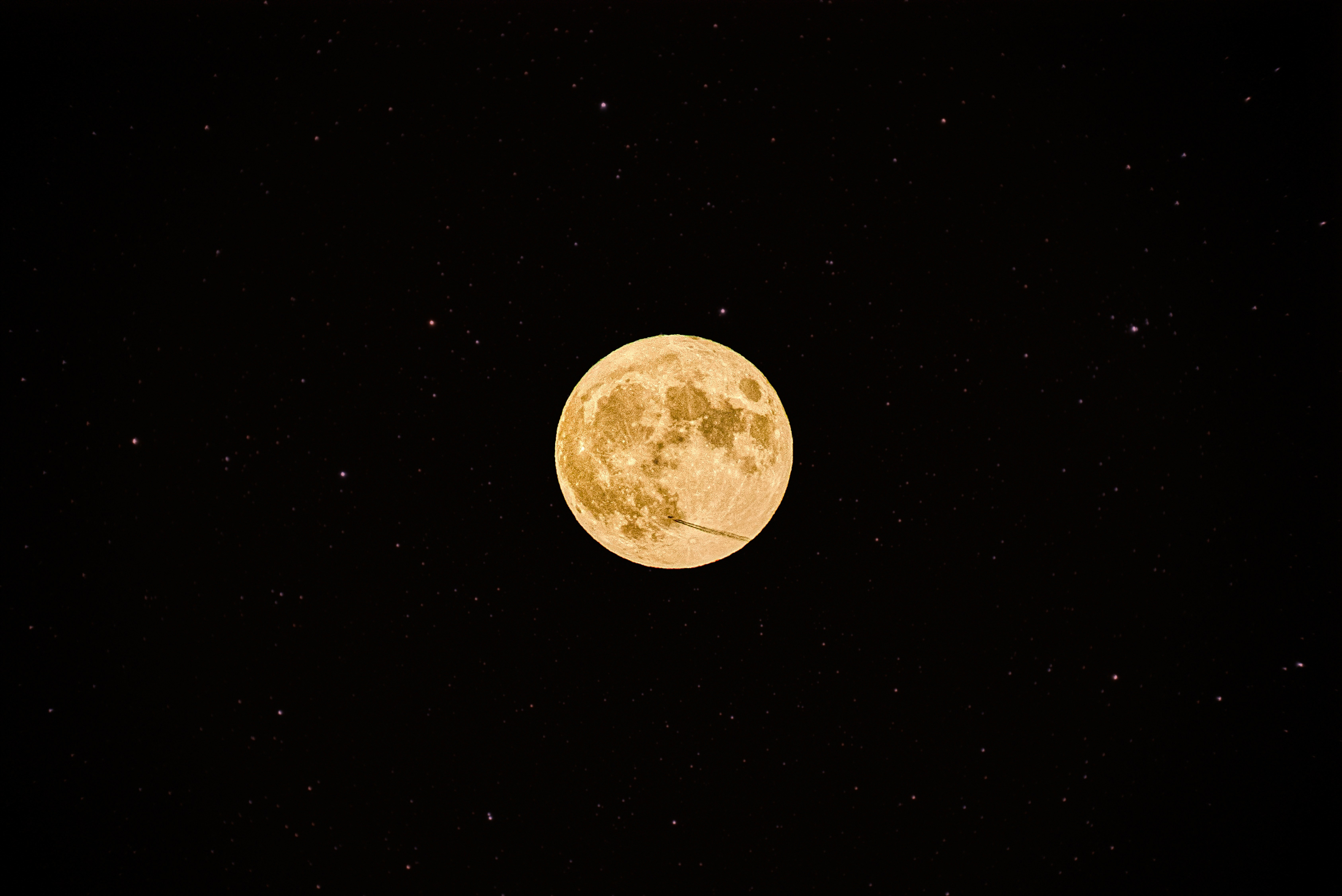 A full moon is seen in the night sky