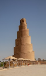 A very tall tower with a clock on it's side