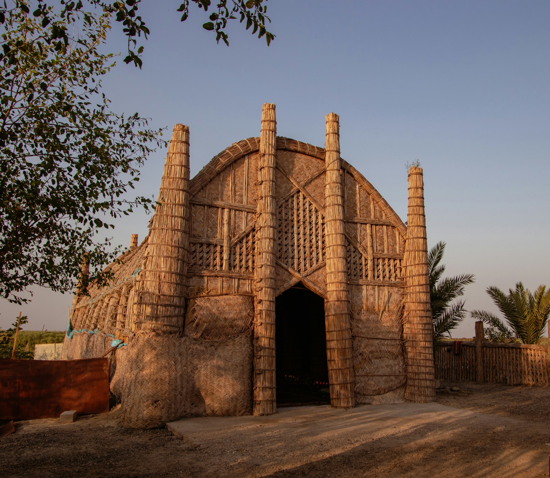 A building made of bricks sitting on top of a dirt road