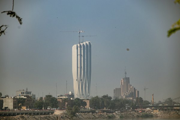 A tall white building sitting next to a body of water — Baghdad, Iraq