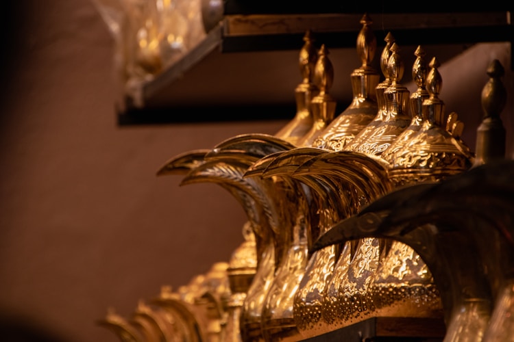 Close-up of an intricate clock mechanism on a wall, symbolizing the precision and tradition behind hallmarking systems that have protected gold buyers for centuries