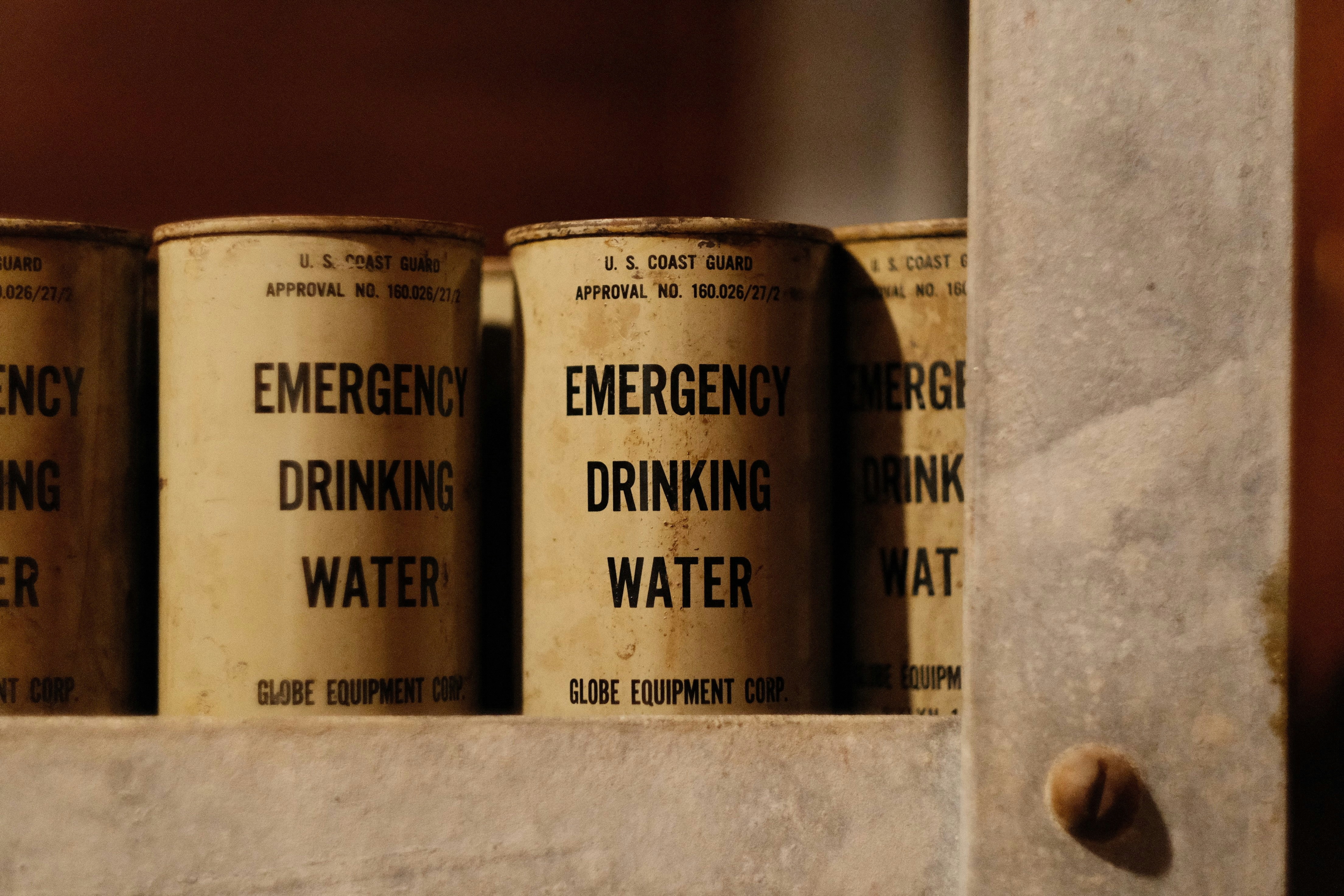 A close up of cans of water on a shelf