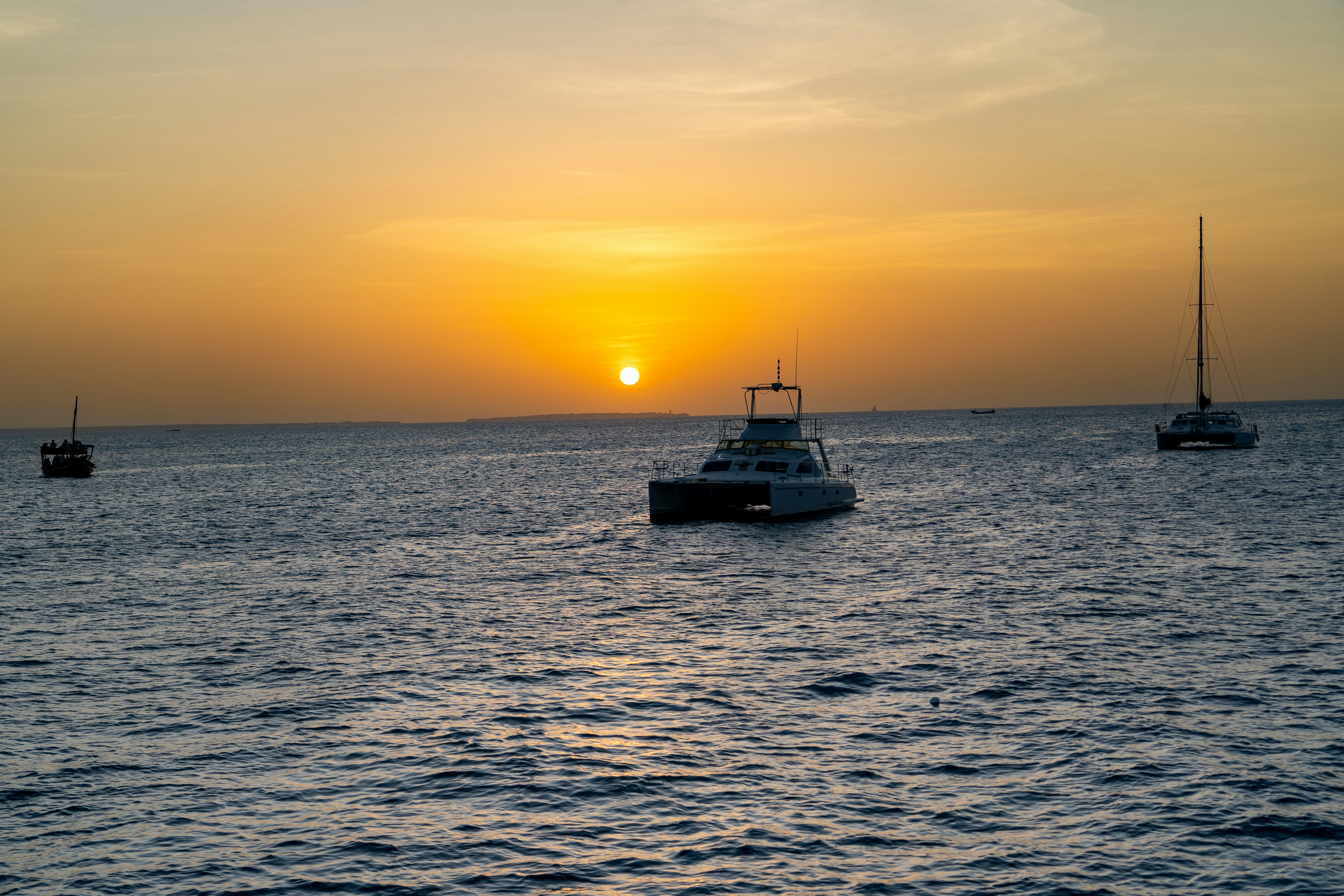 A group of boats floating on top of a large body of water