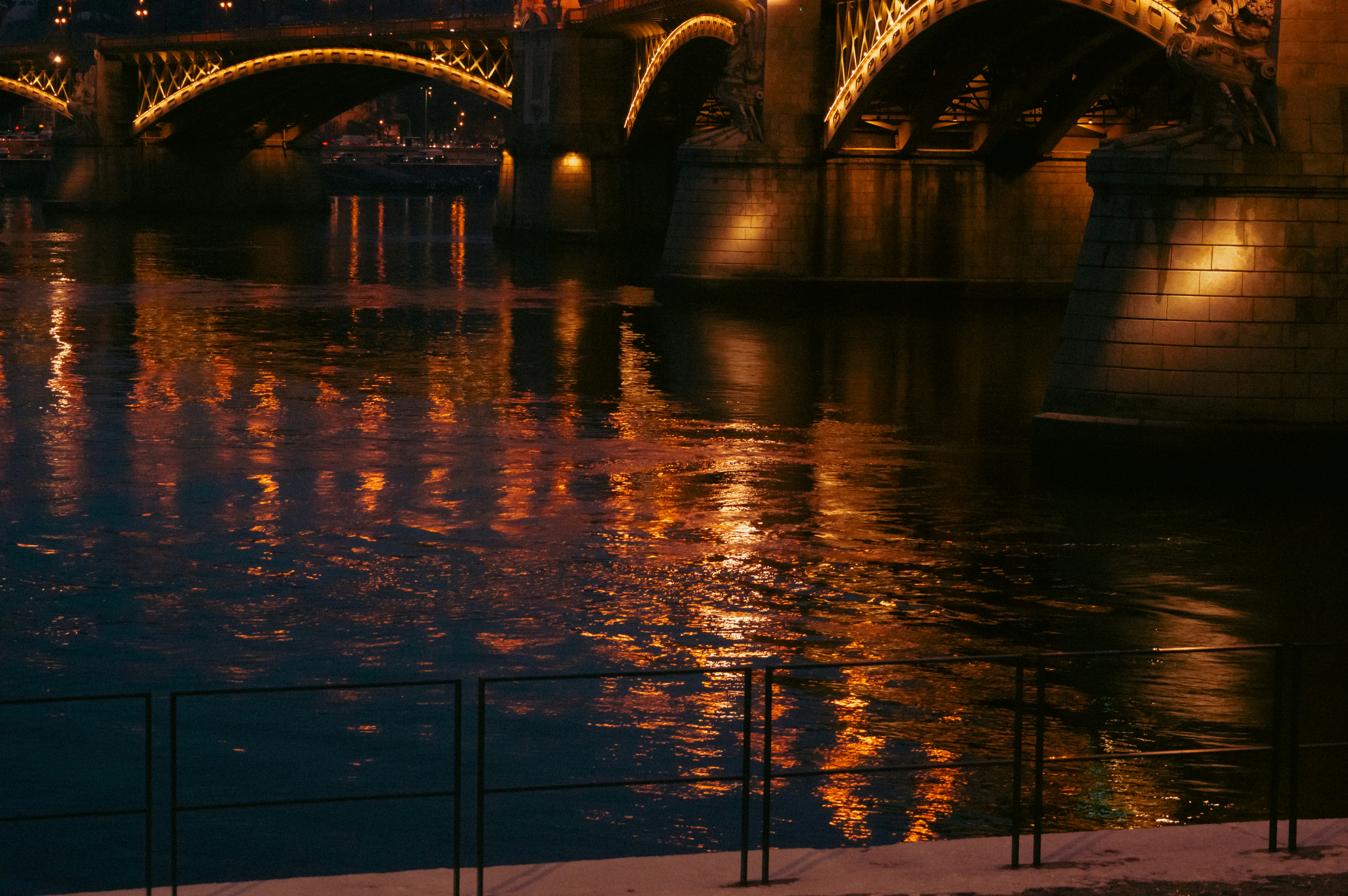 A bridge over a body of water at night