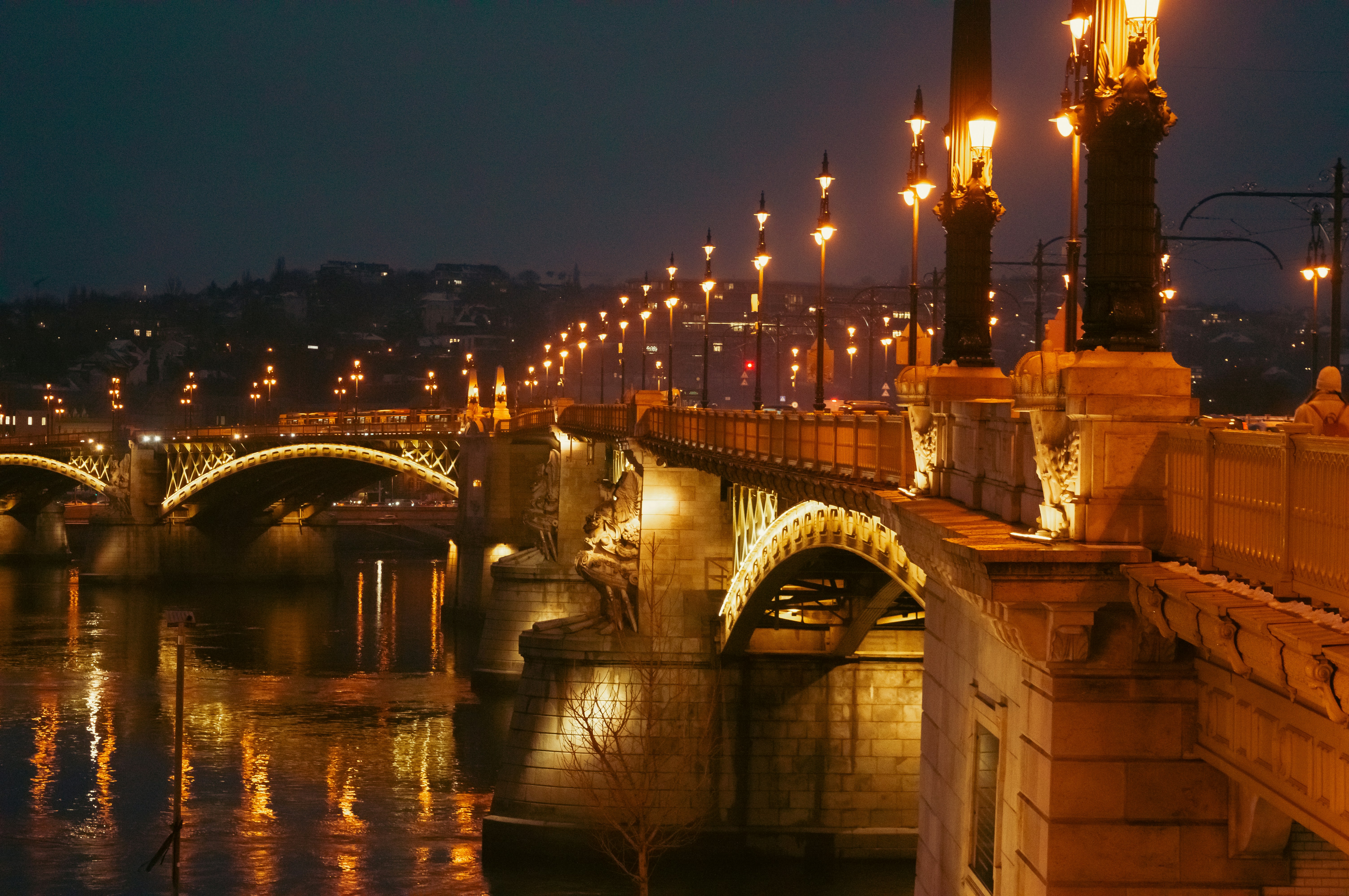 A bridge over a body of water at night