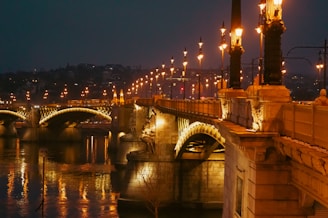 A bridge over a body of water at night
