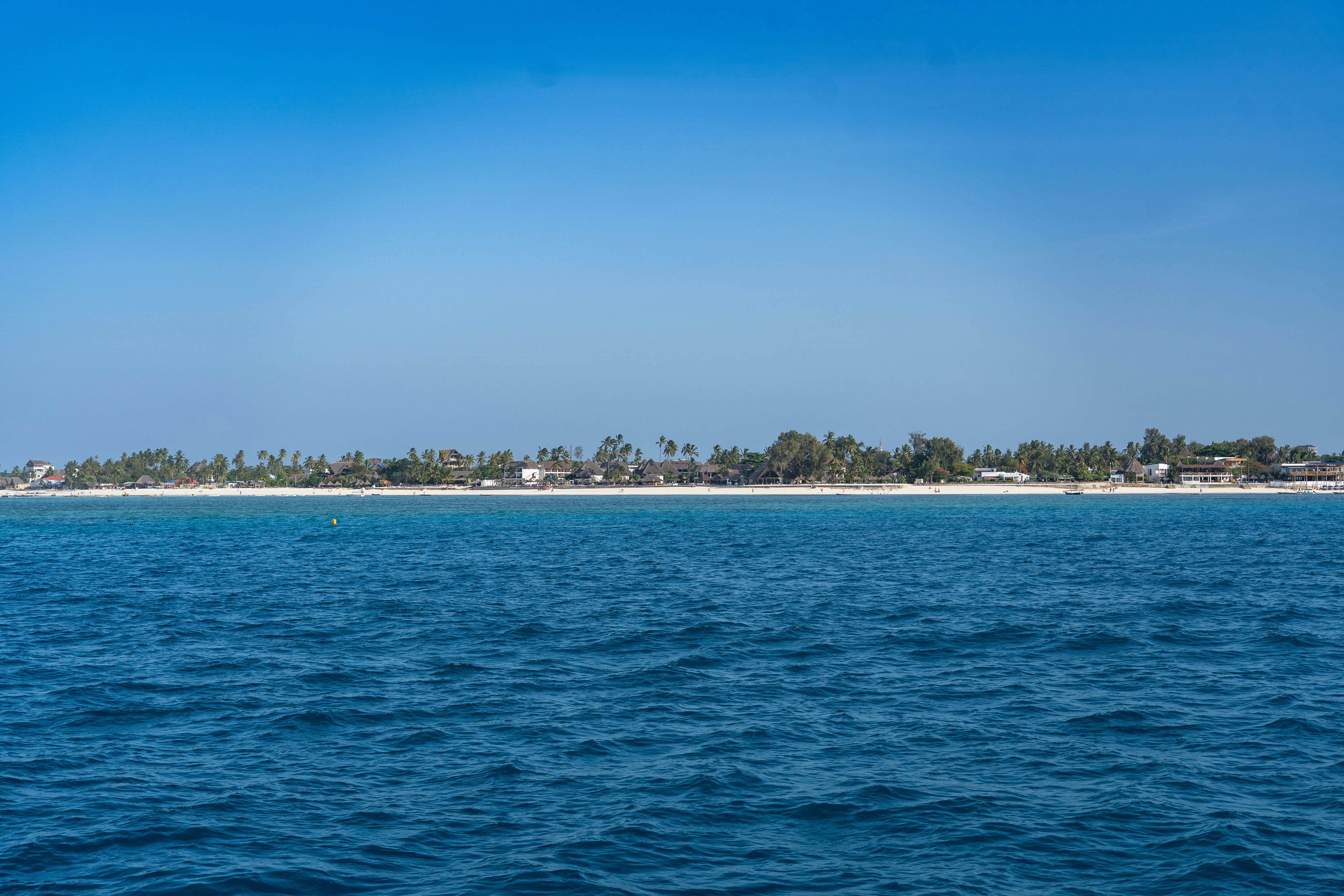 A small island in the middle of a body of water
