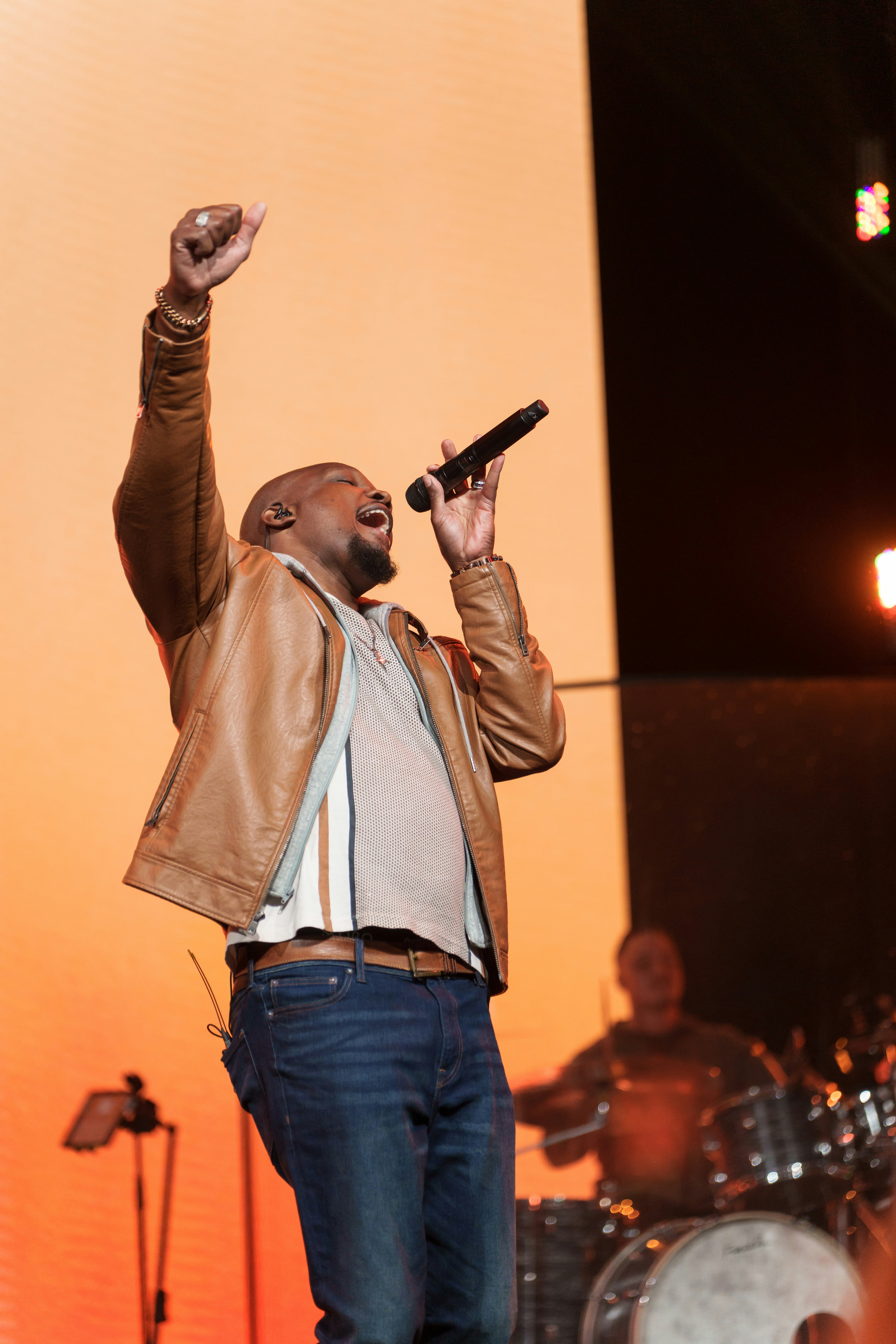 A man standing on a stage holding a microphone