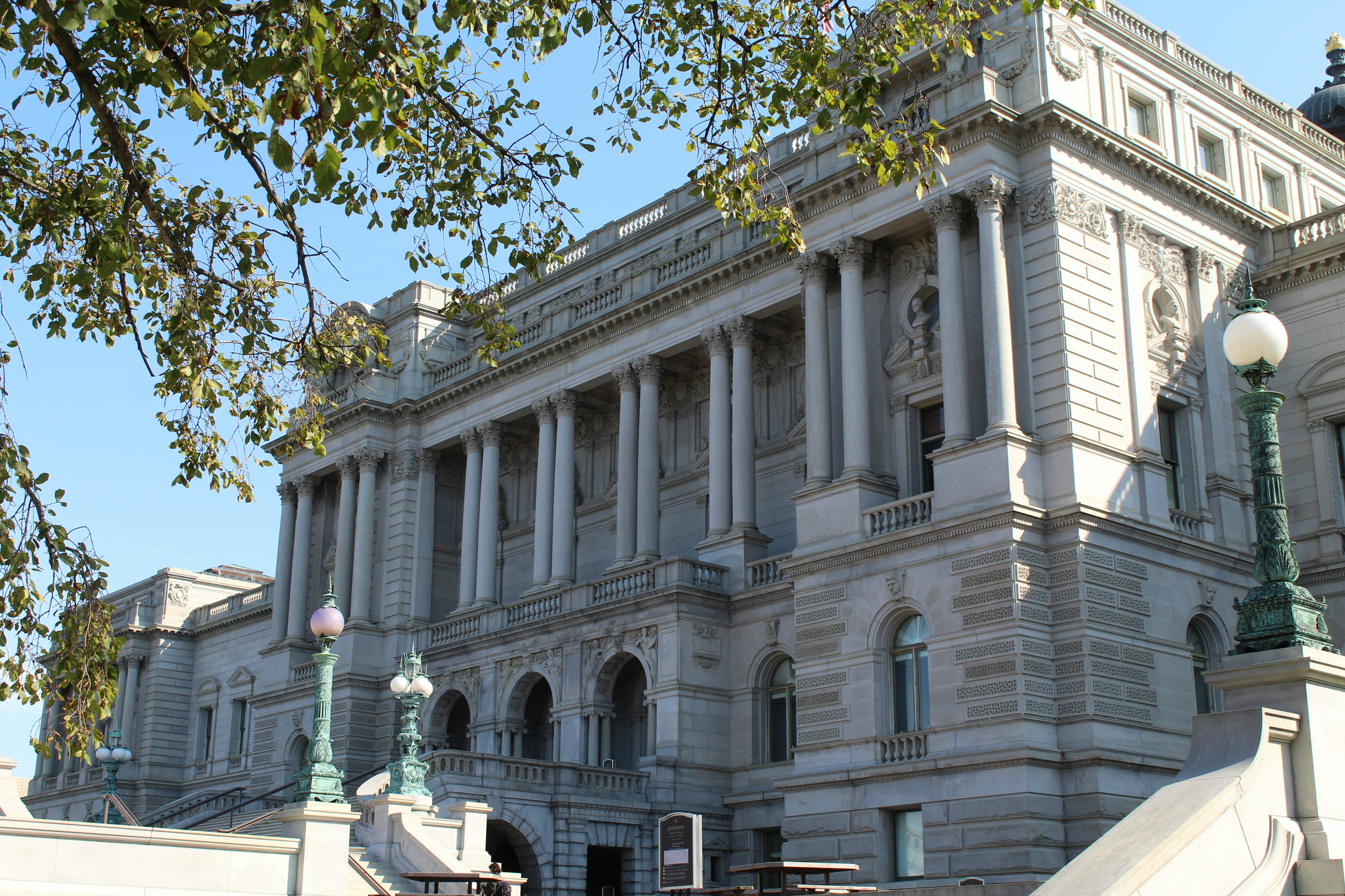 A large white building with a clock on the top of it