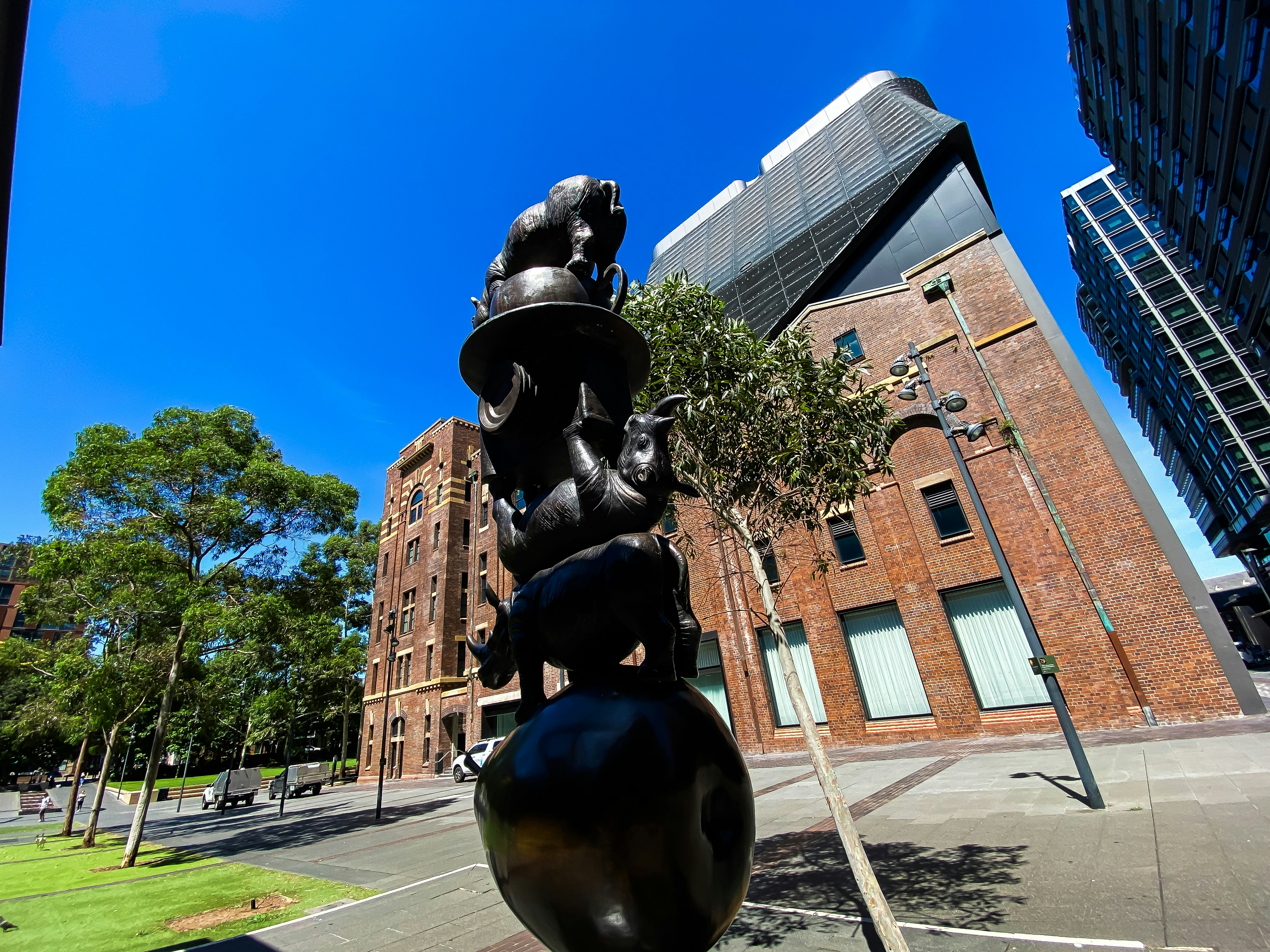 A statue of a man on a pedestal in front of a building