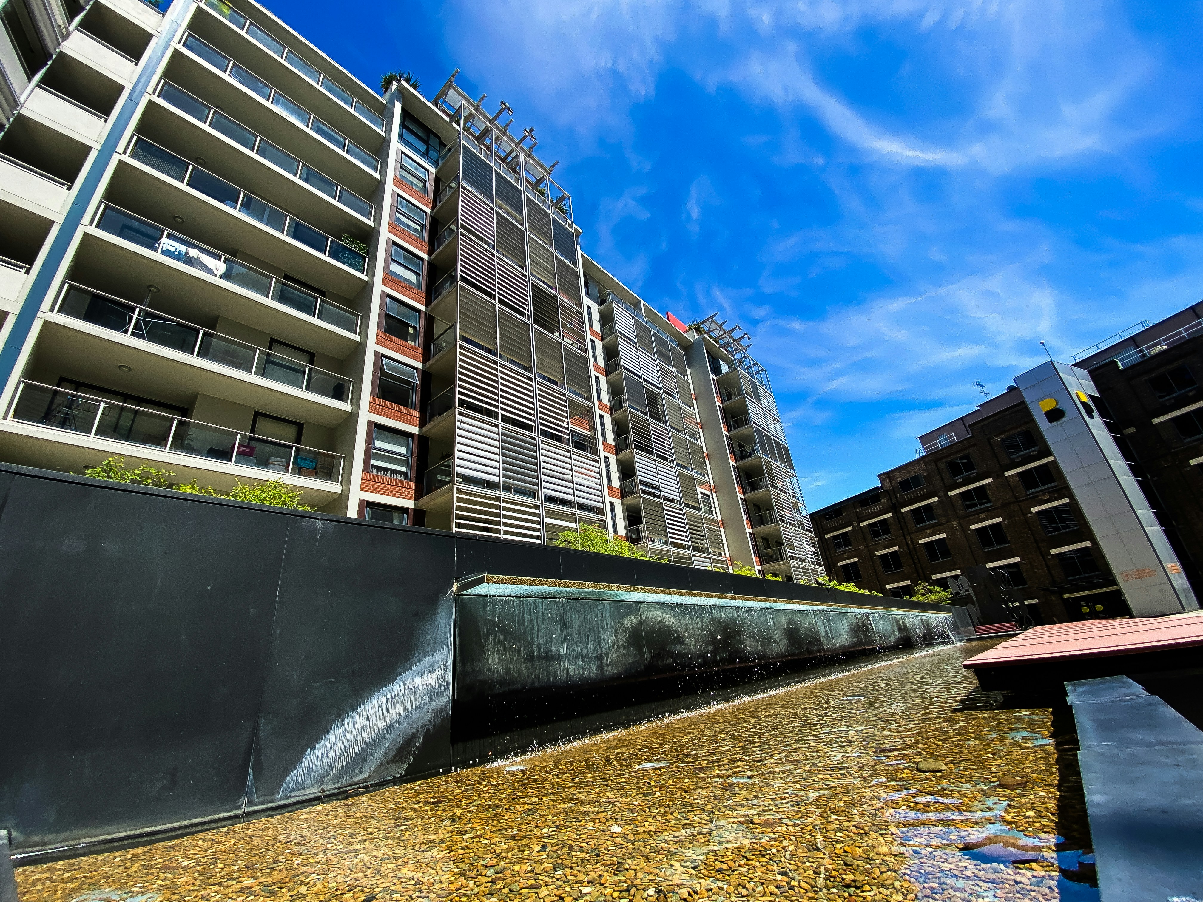 A picture of a very tall building next to a body of water