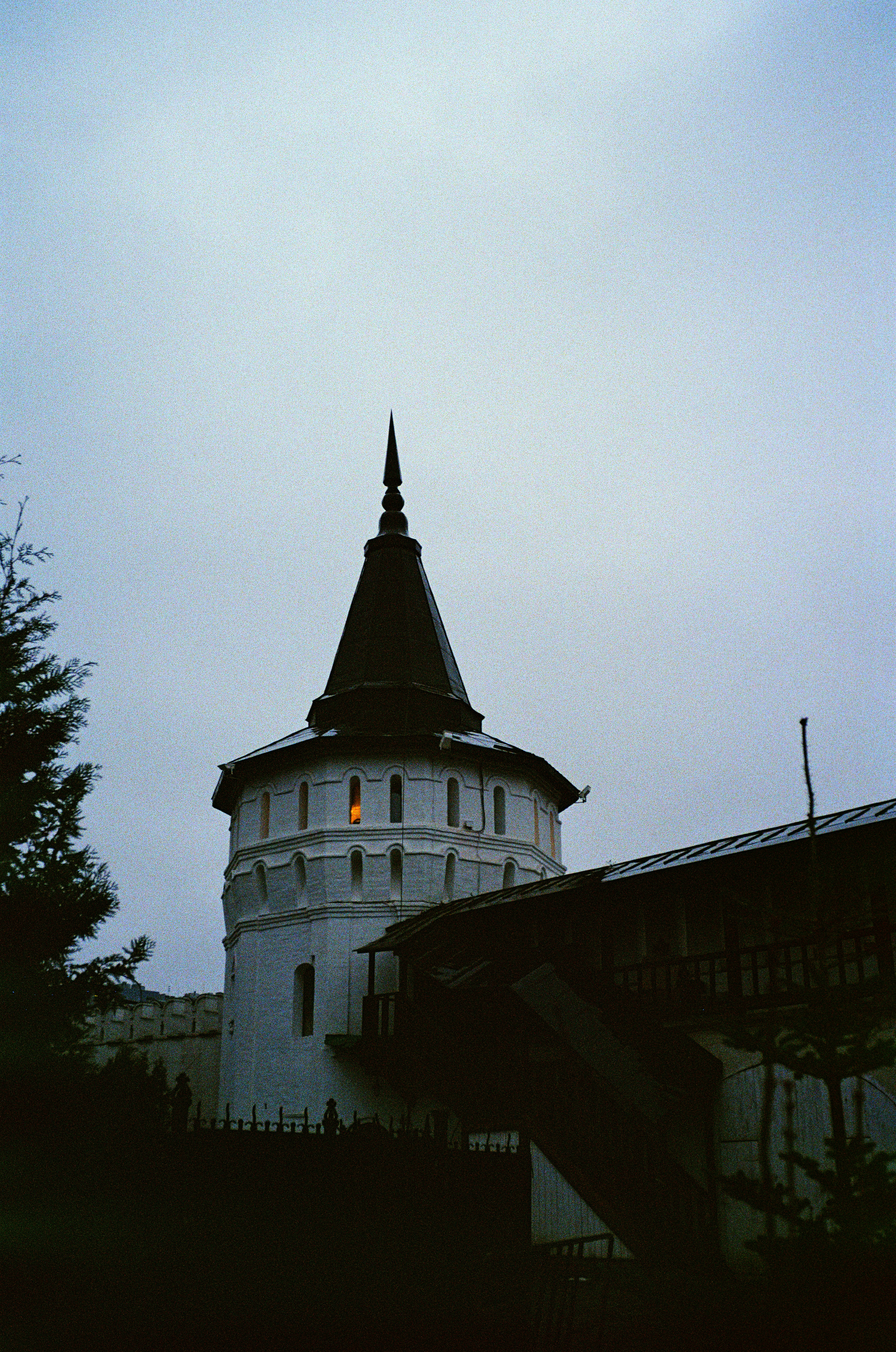 A white building with a steeple on a cloudy day