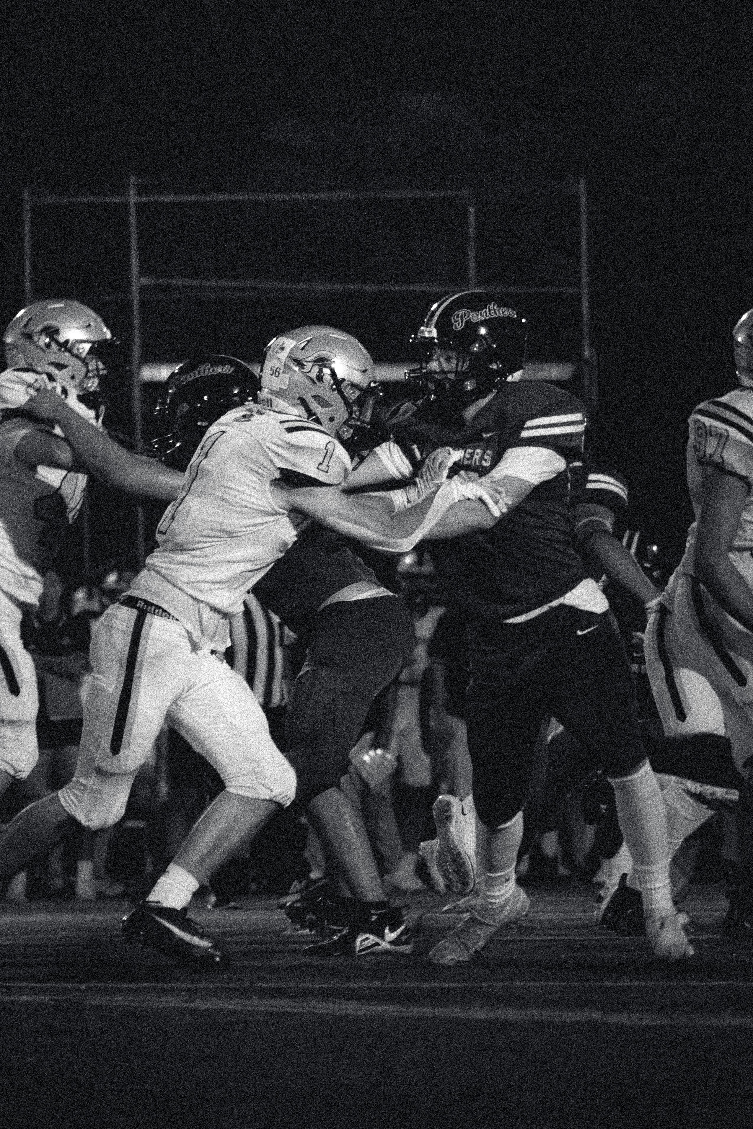 A football game is being played in black and white