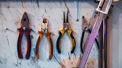 A bunch of tools hanging on a wall