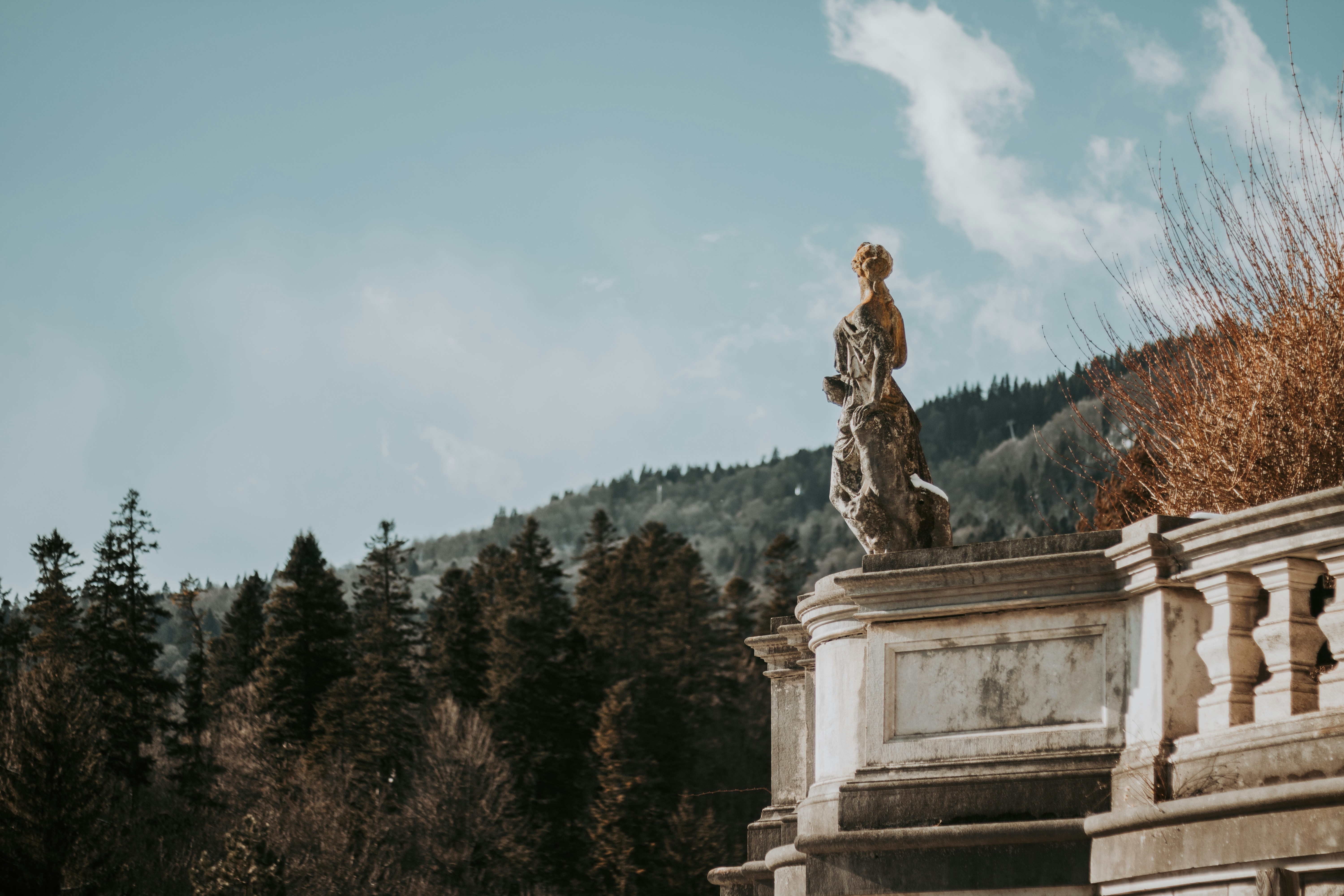 A statue of a woman standing on top of a building
