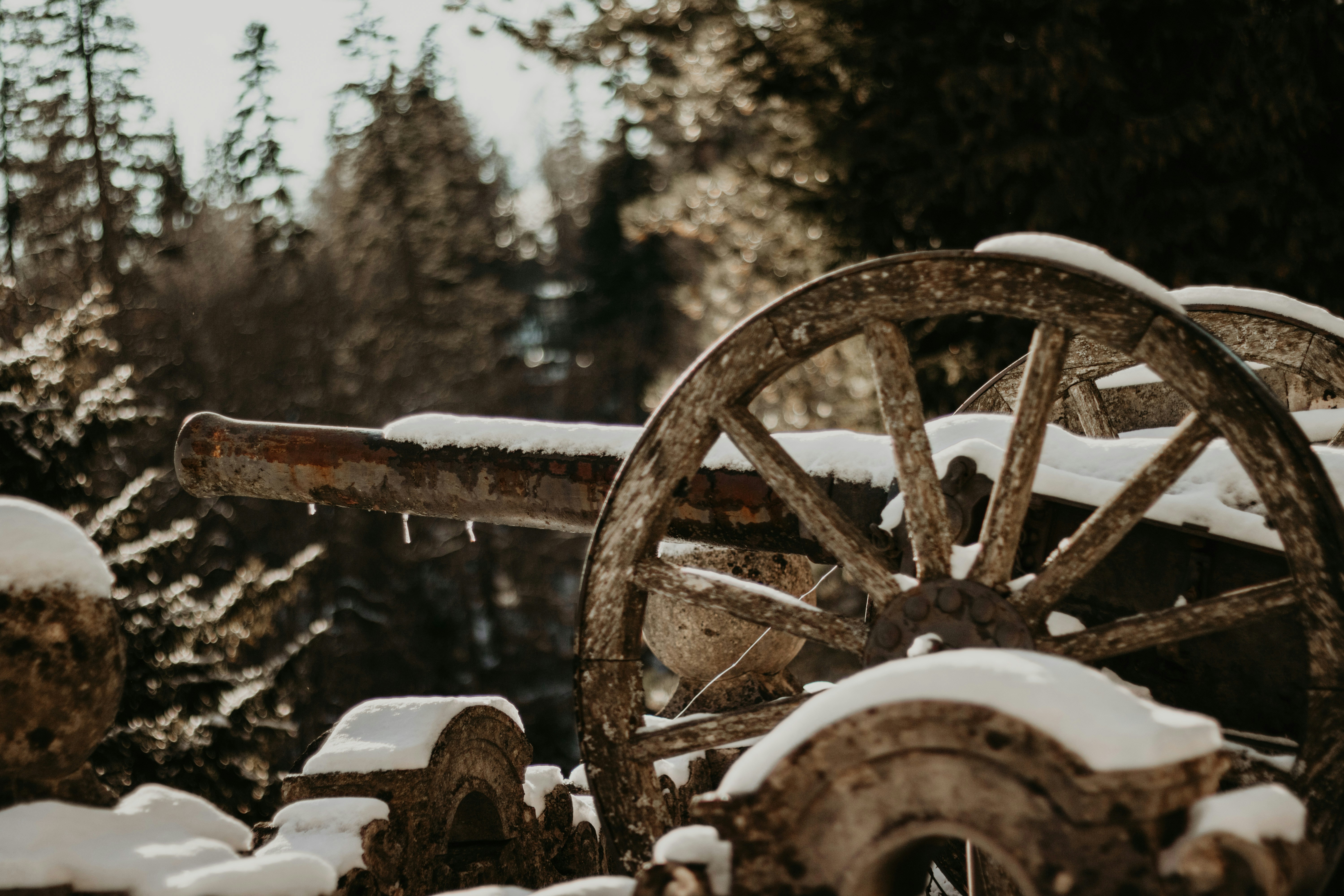 An old wooden wagon is covered in snow