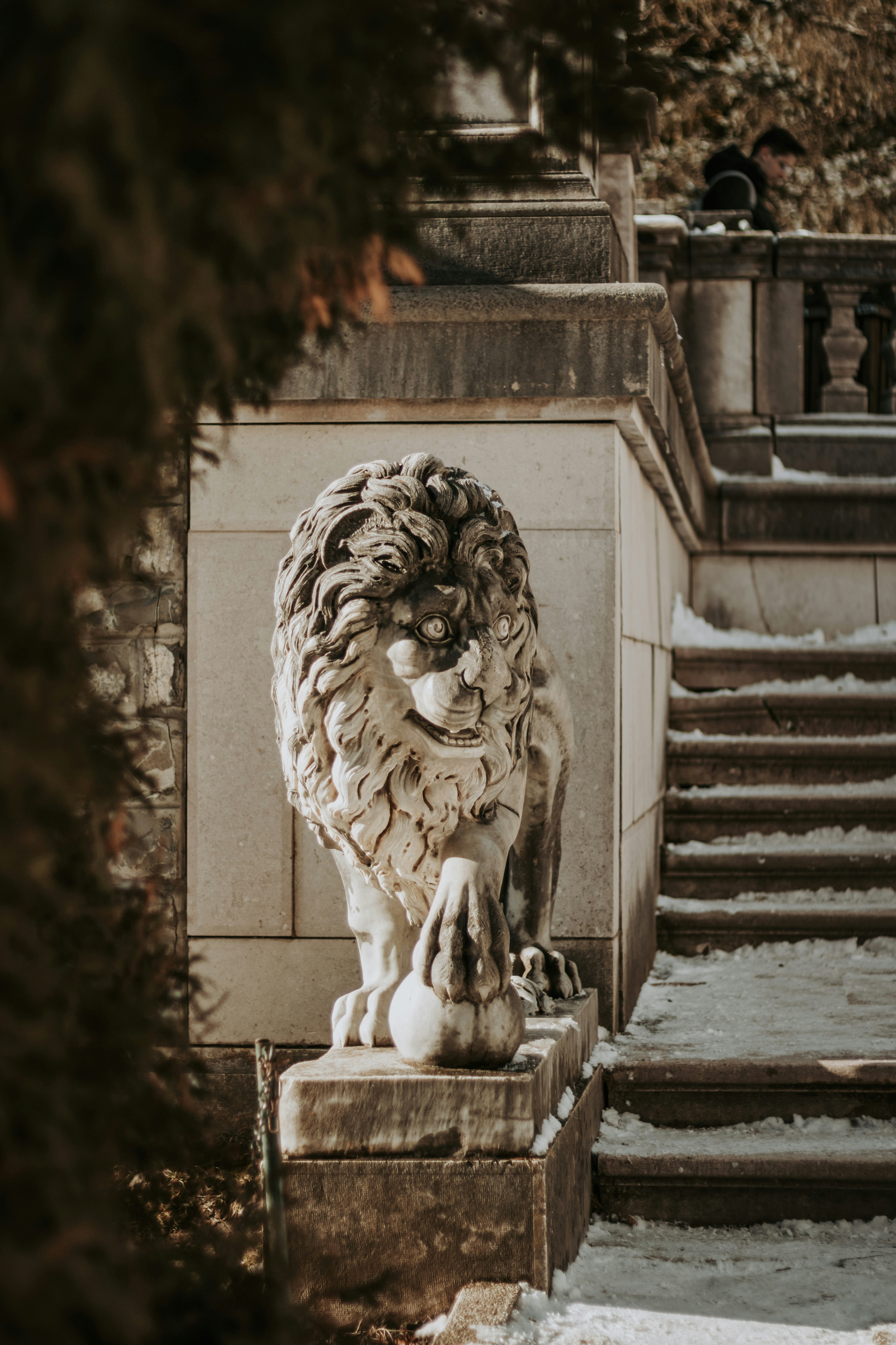 A statue of a lion sitting in front of a staircase