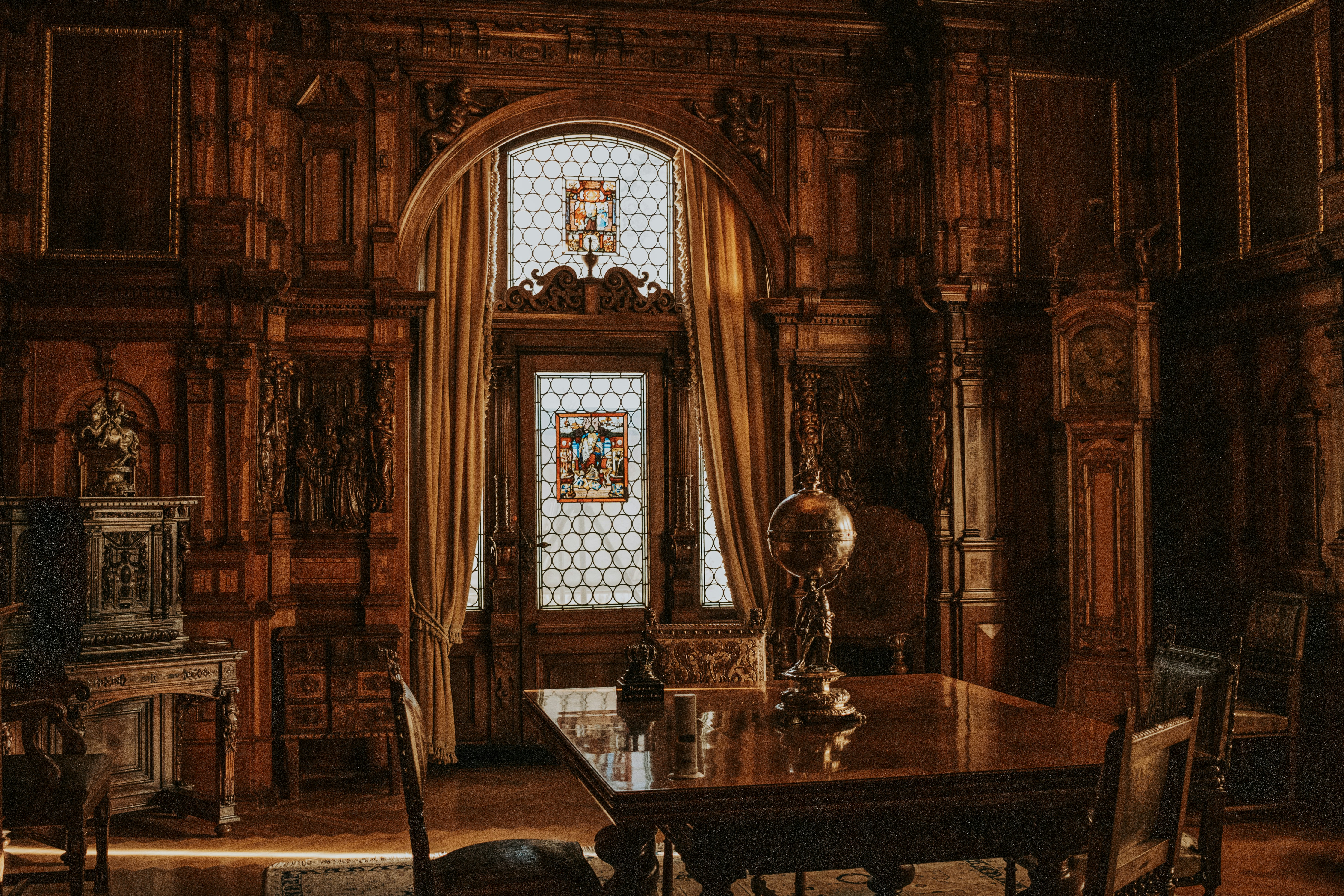 A dining room with a large wooden table and chairs