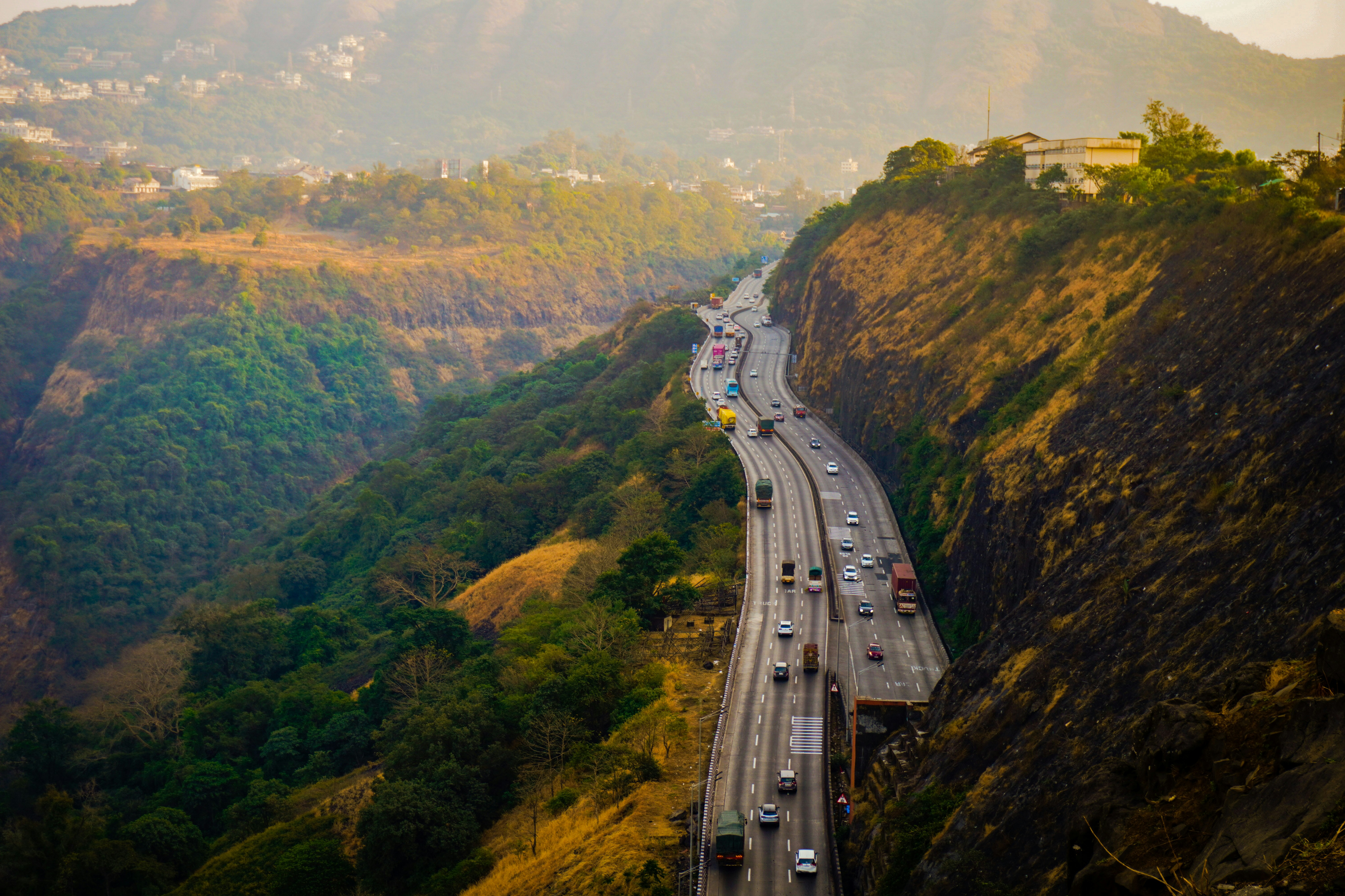 A view of a highway with mountains in the background