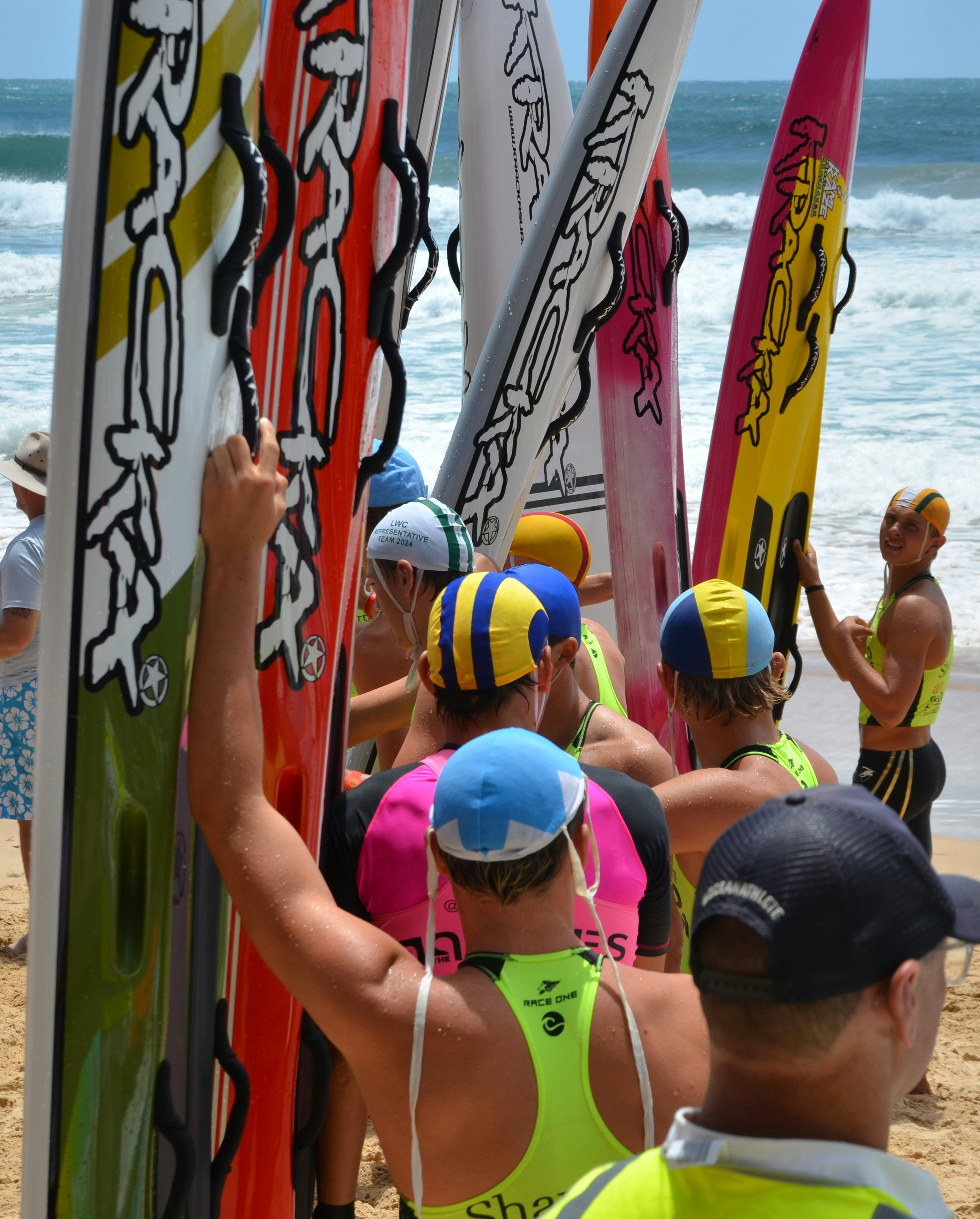 A group of people standing on top of a sandy beach