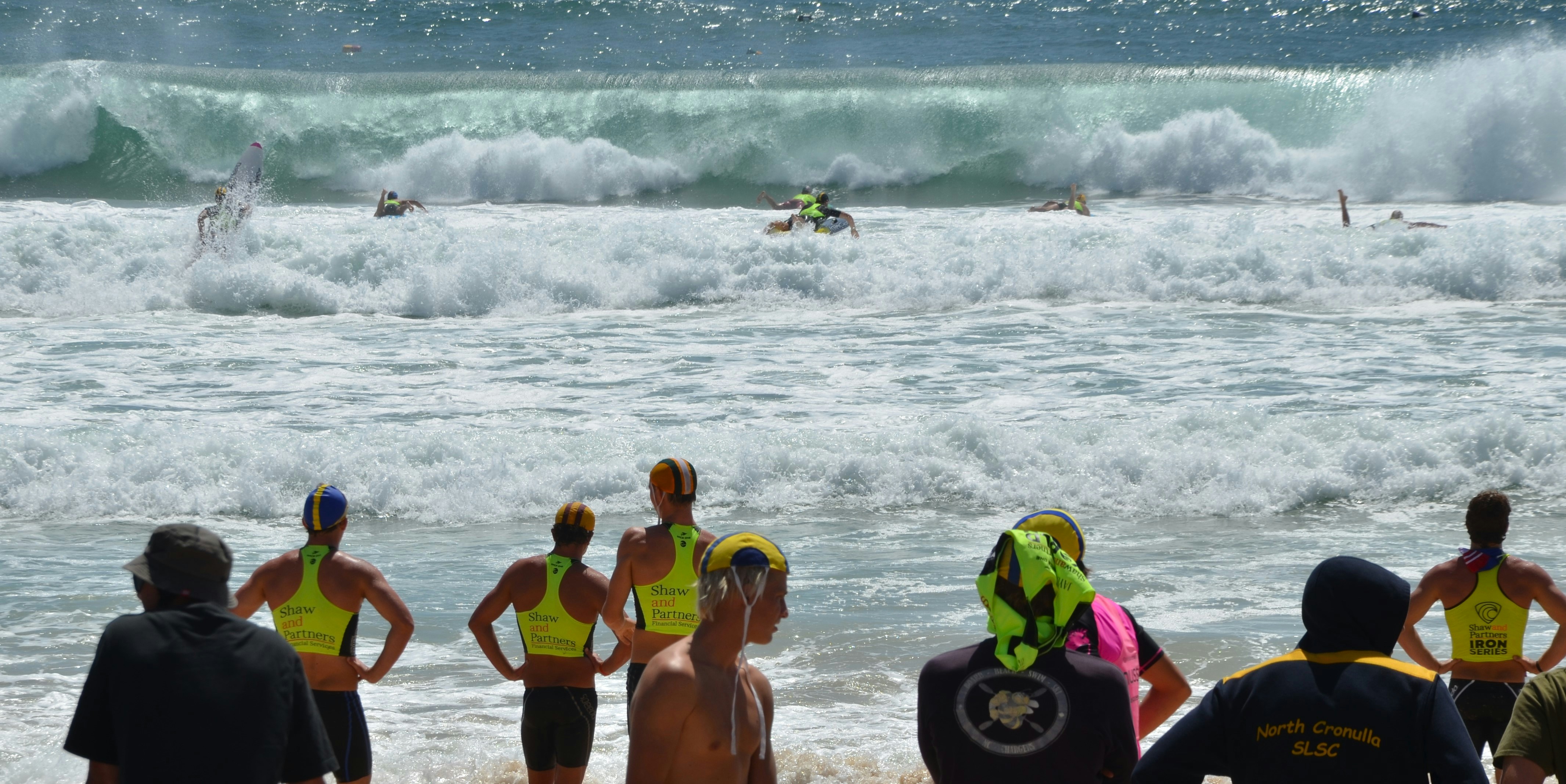 A group of people standing on top of a beach