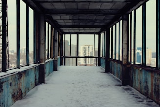 An empty walkway with snow on the ground