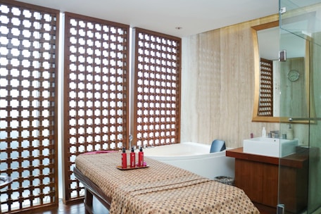 A spa room with a spa bed and a shower