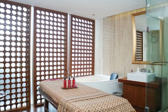 A spa room with a spa bed and a shower