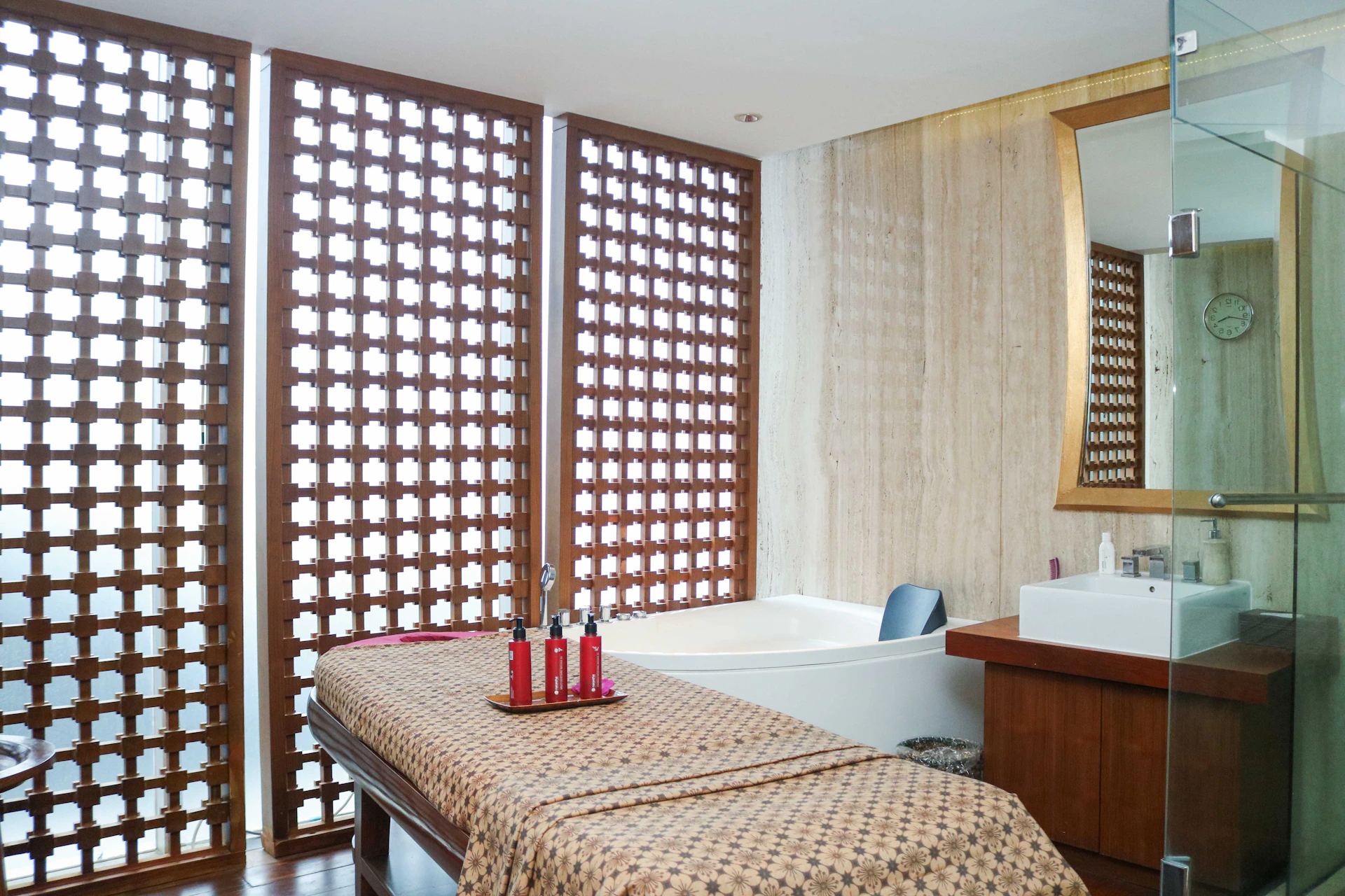 A spa room with a spa bed and a shower
